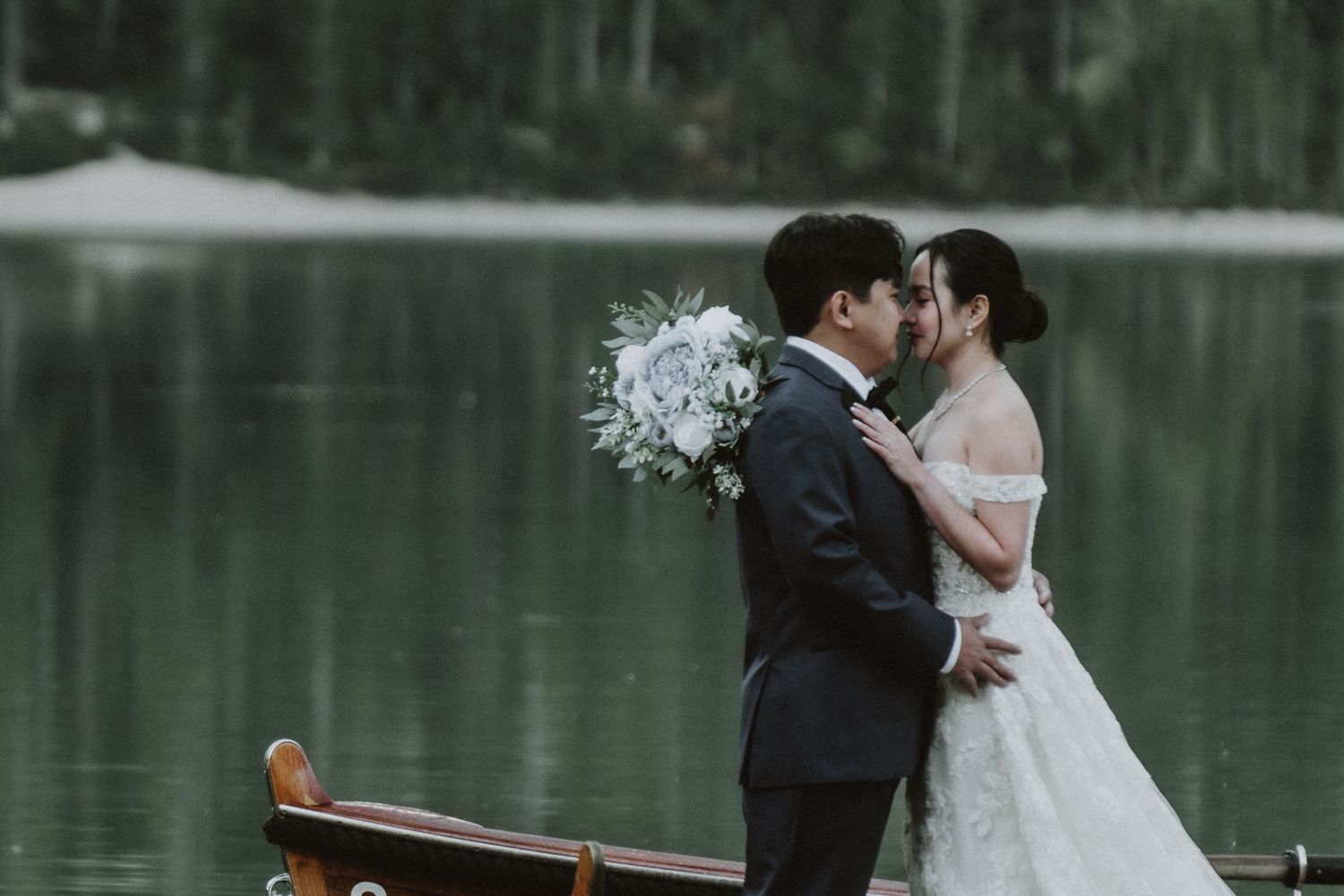 lakeside wedding portrait  – couple embracing by the water