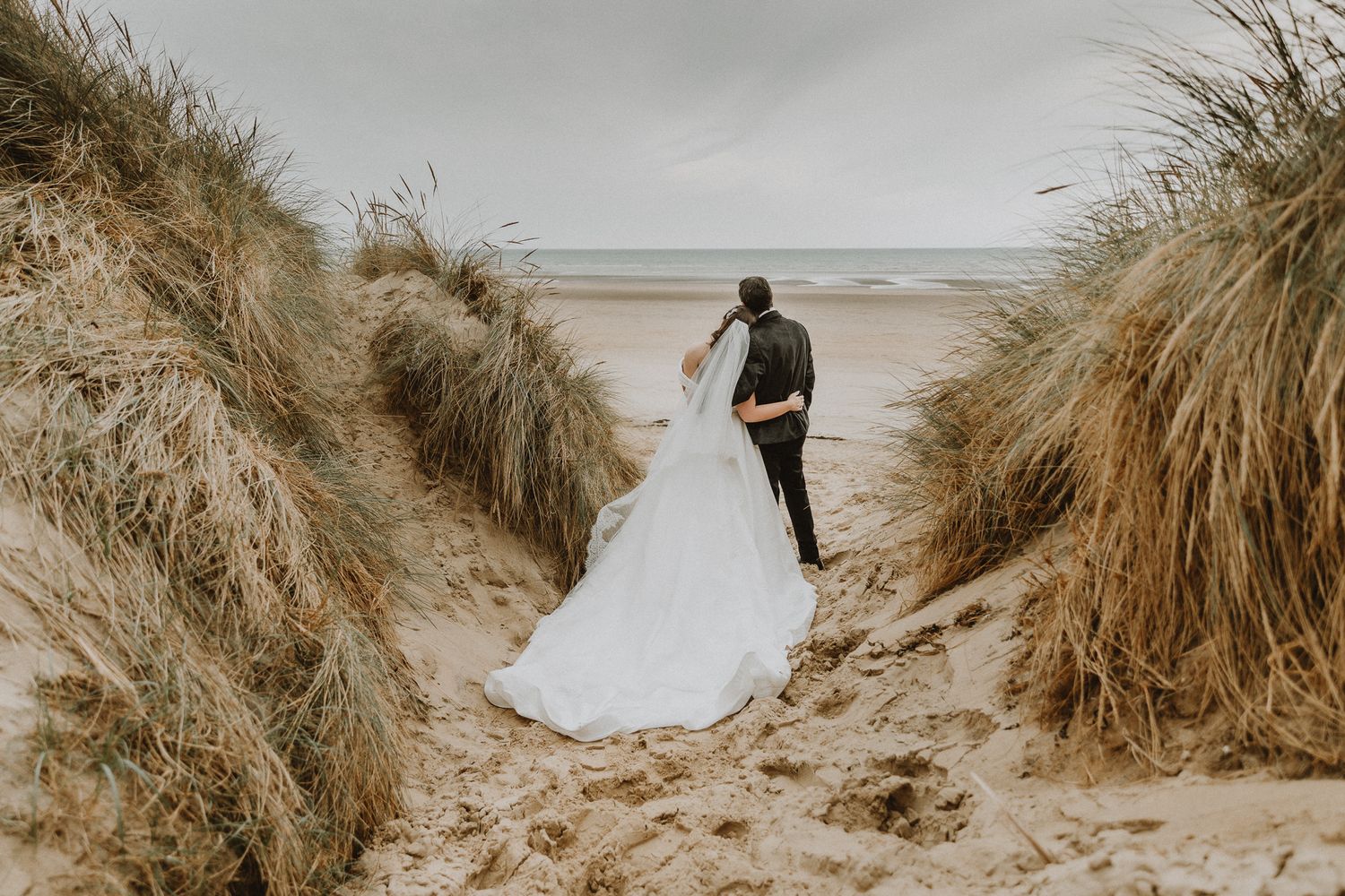 elopement photography in Kent – bride and groom in golden dune landscape