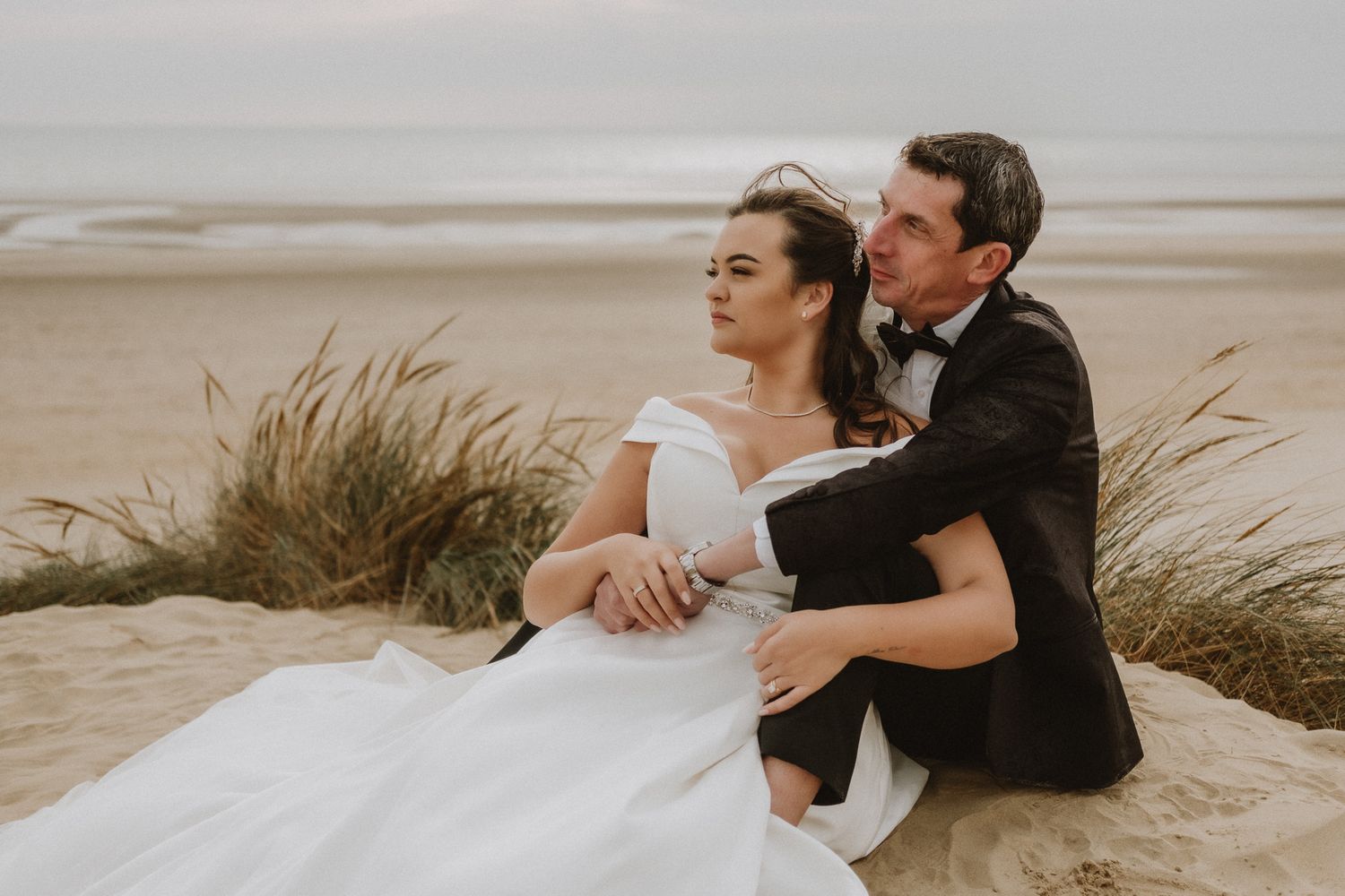 intimate coastal wedding portrait in Kent – bride and groom against dune backdrop