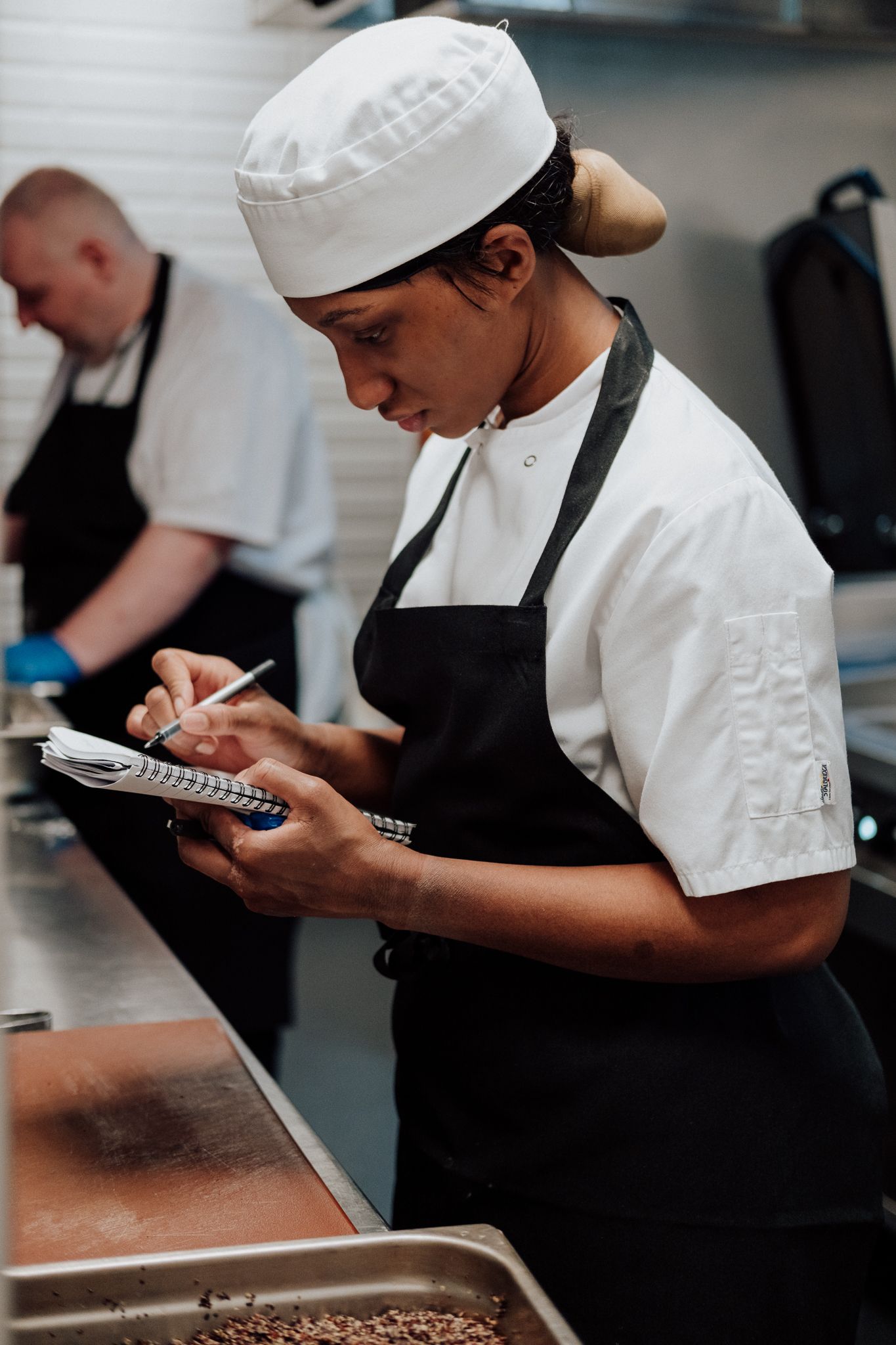 brand story photography in London – chef preparing menu in professional kitchen