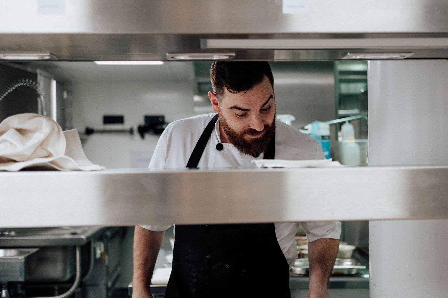 kitchen photography in London – chef working at stainless steel workstation