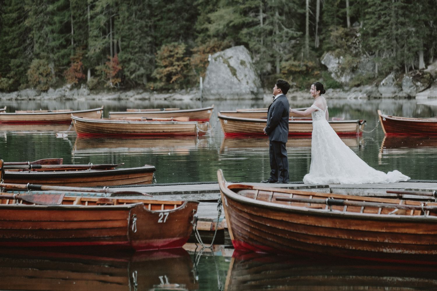 candid wedding photography  – couple laughing by the lake