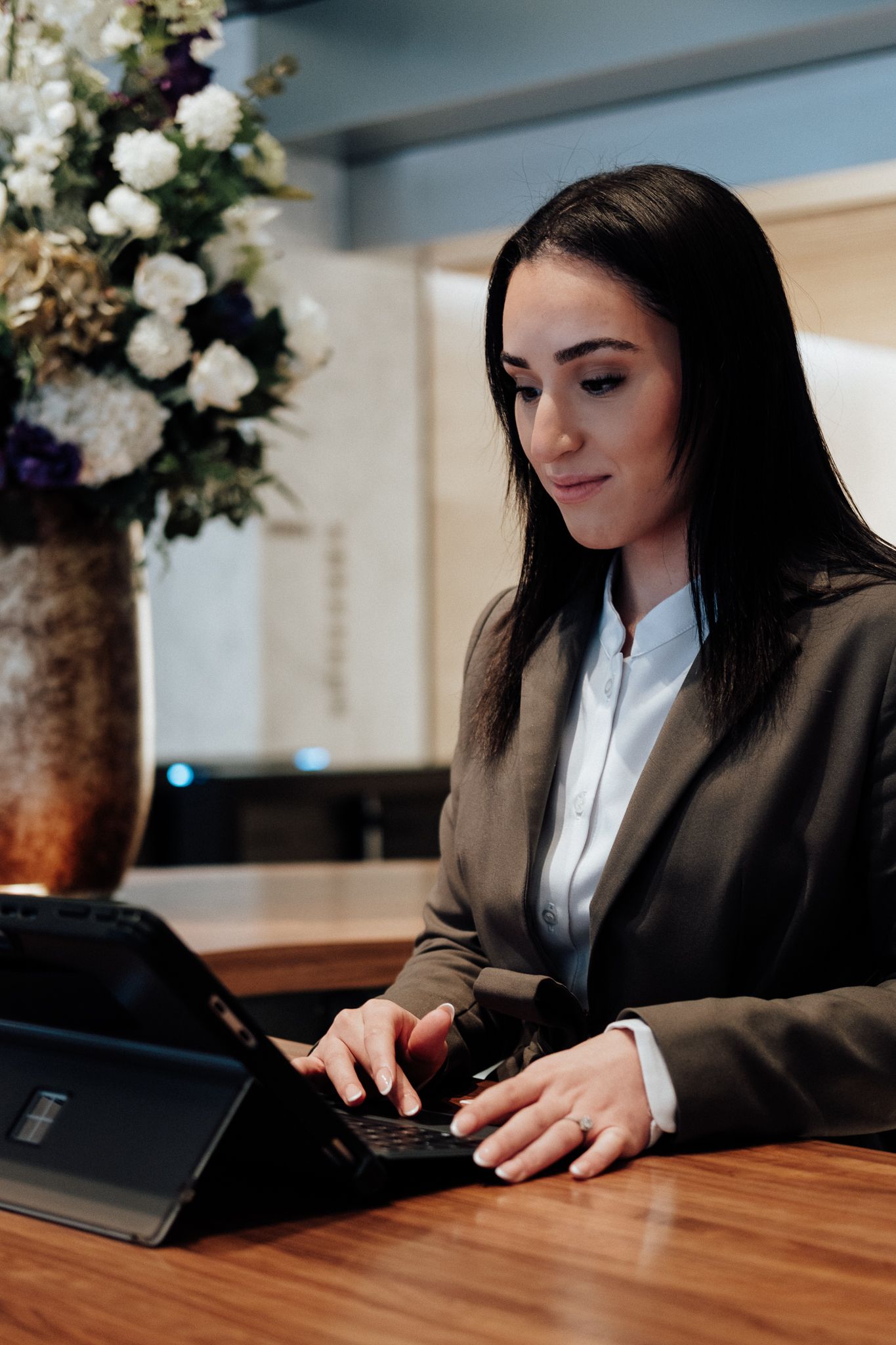 personal branding photography in London – businesswoman working on laptop in contemporary interior