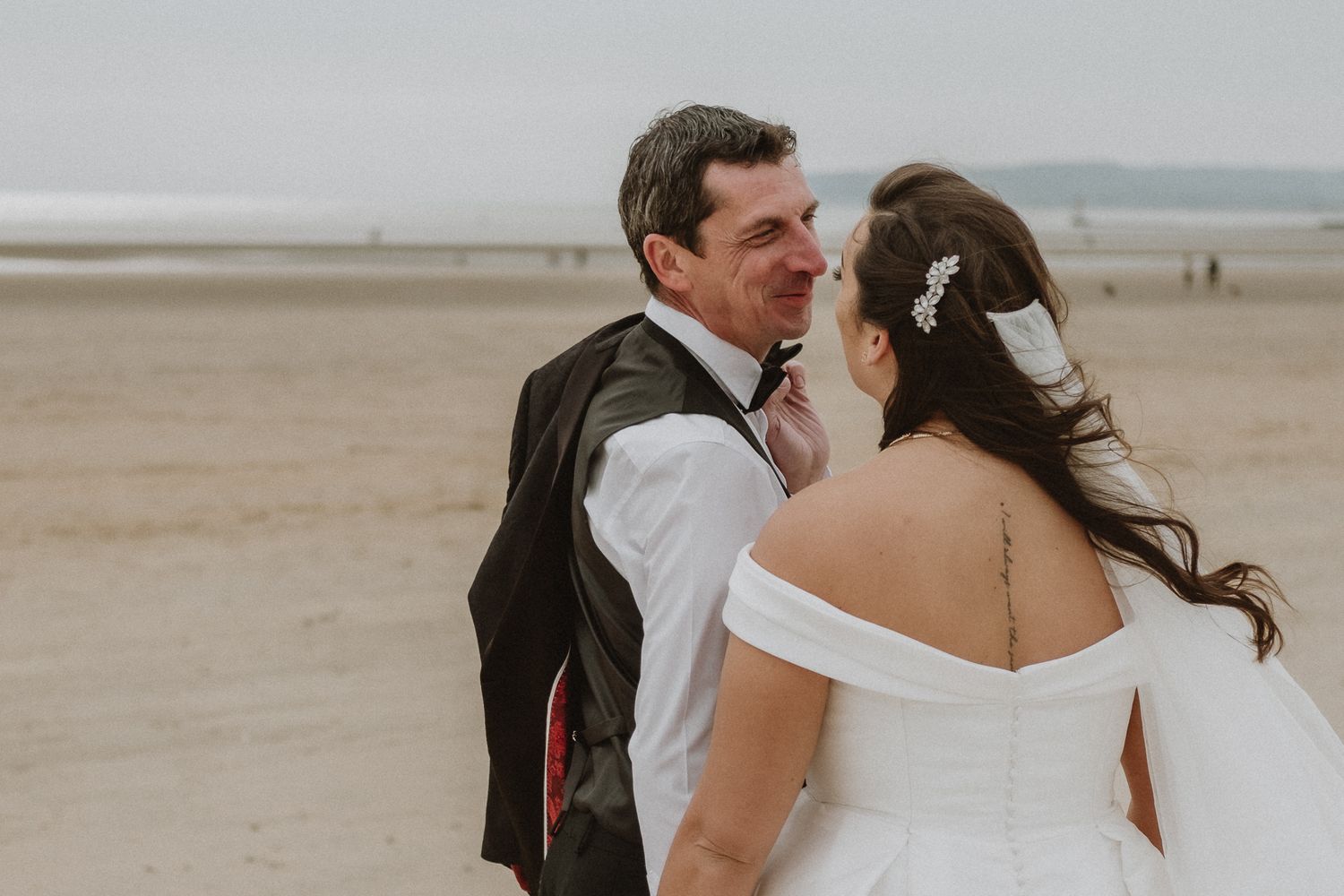 elopement photography in Kent – newlyweds walking along the beach