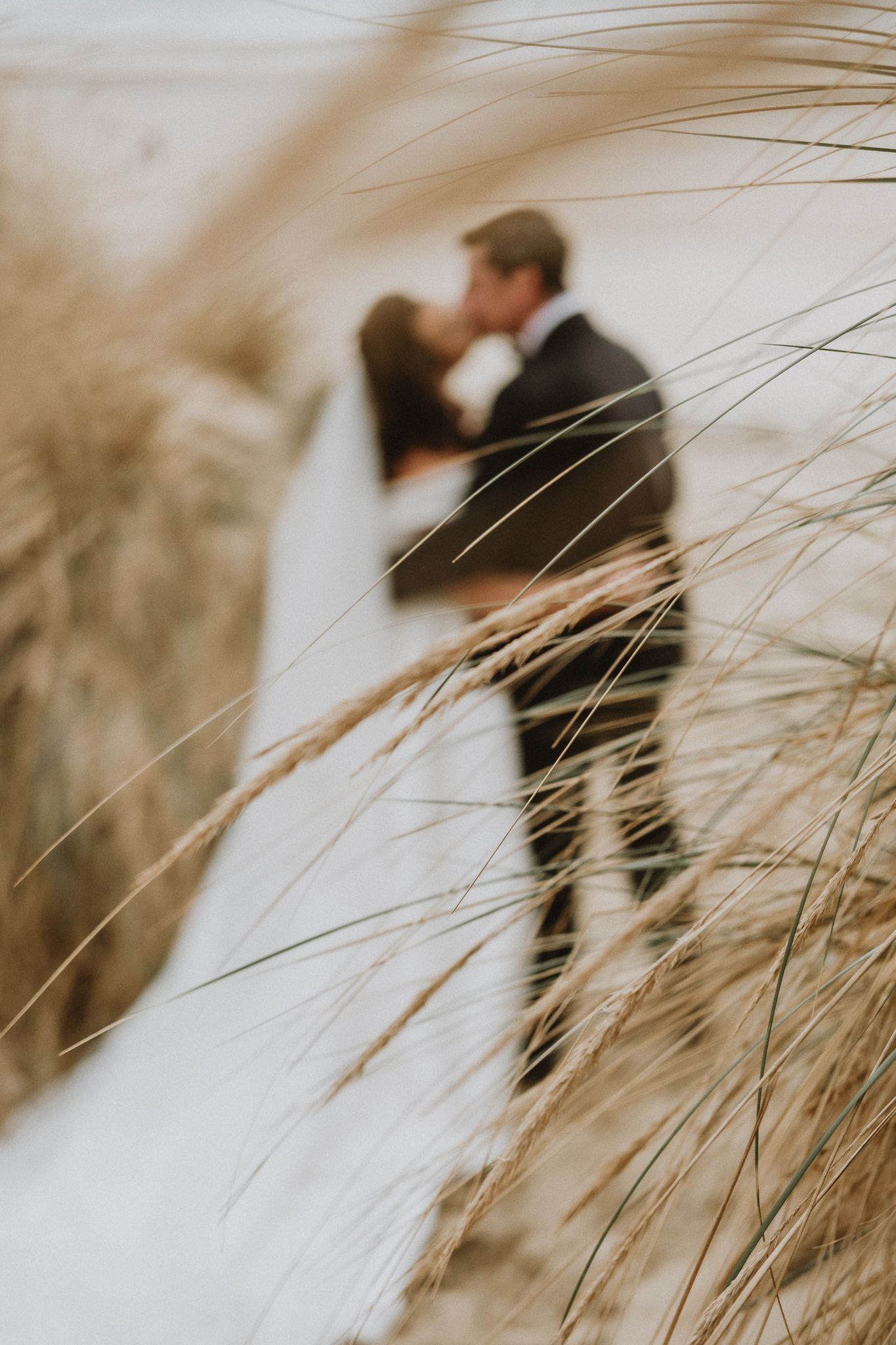documentary wedding photography in Kent – candid laughter on sand dunes