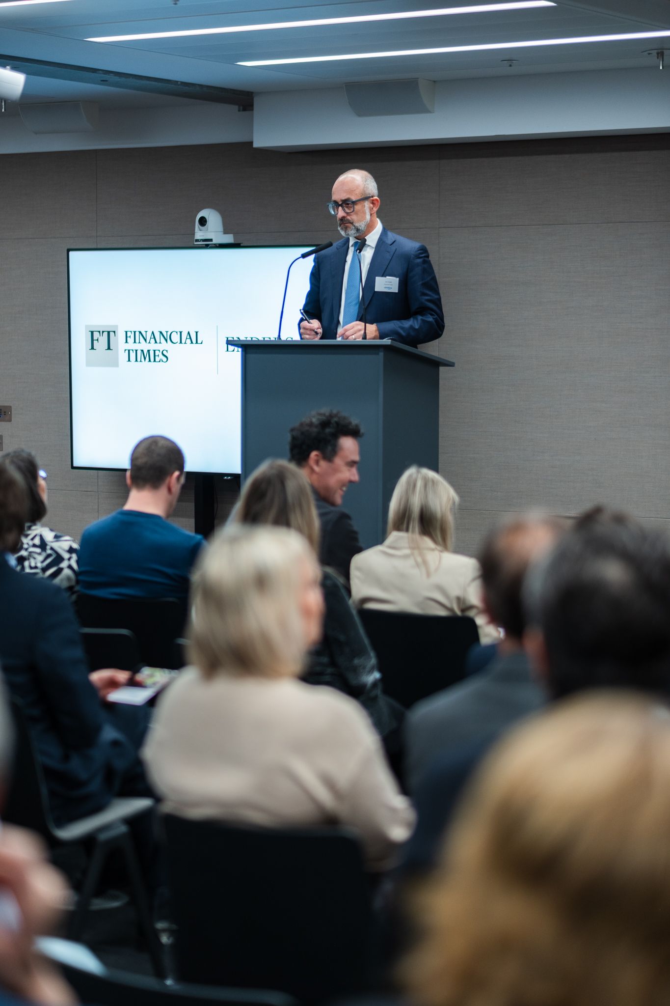 indoor event photography in London– speaker addressing guests at charity gathering