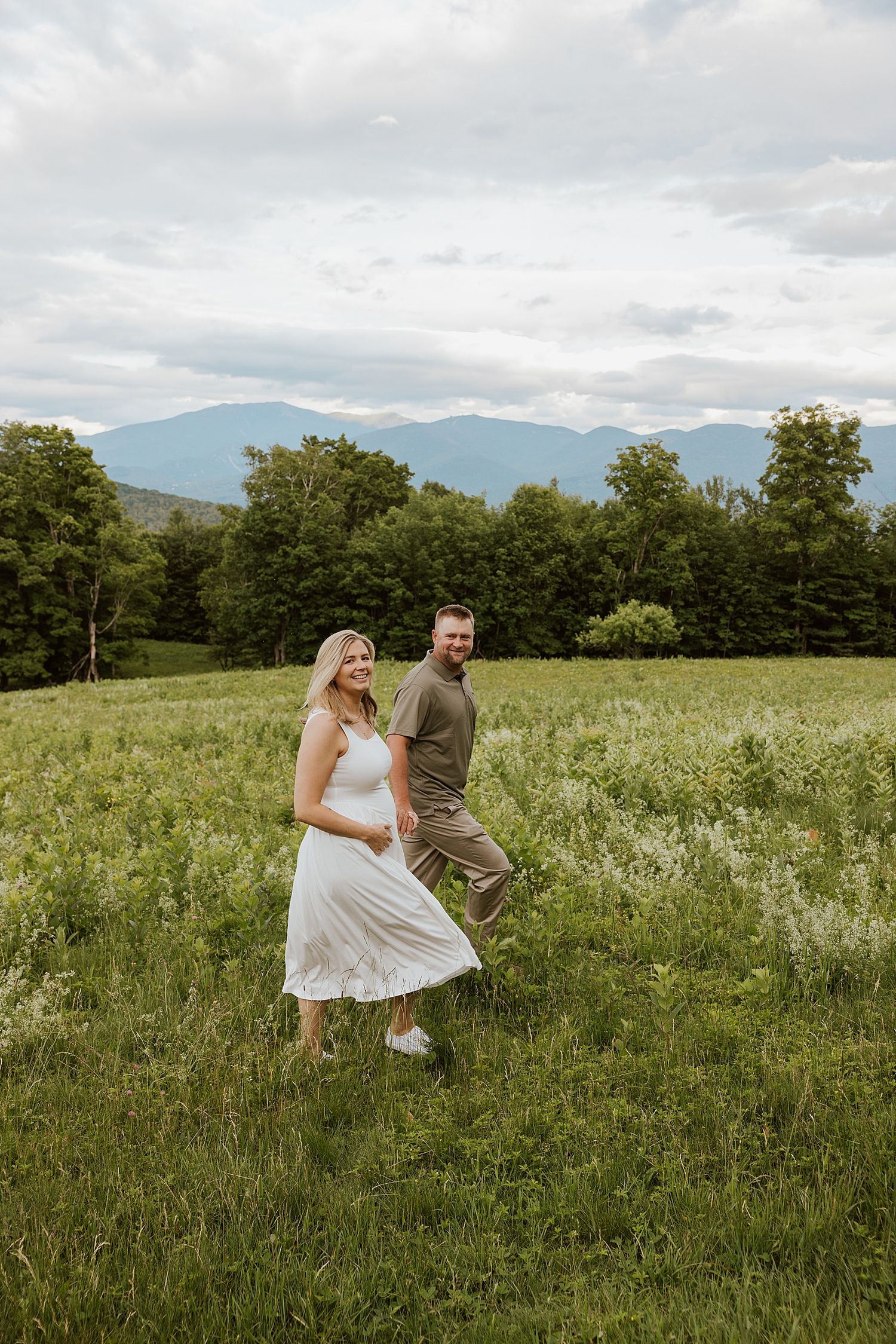 Couple taking maternity photos in New Hampshire's mountains, sharing maternity photo session tips