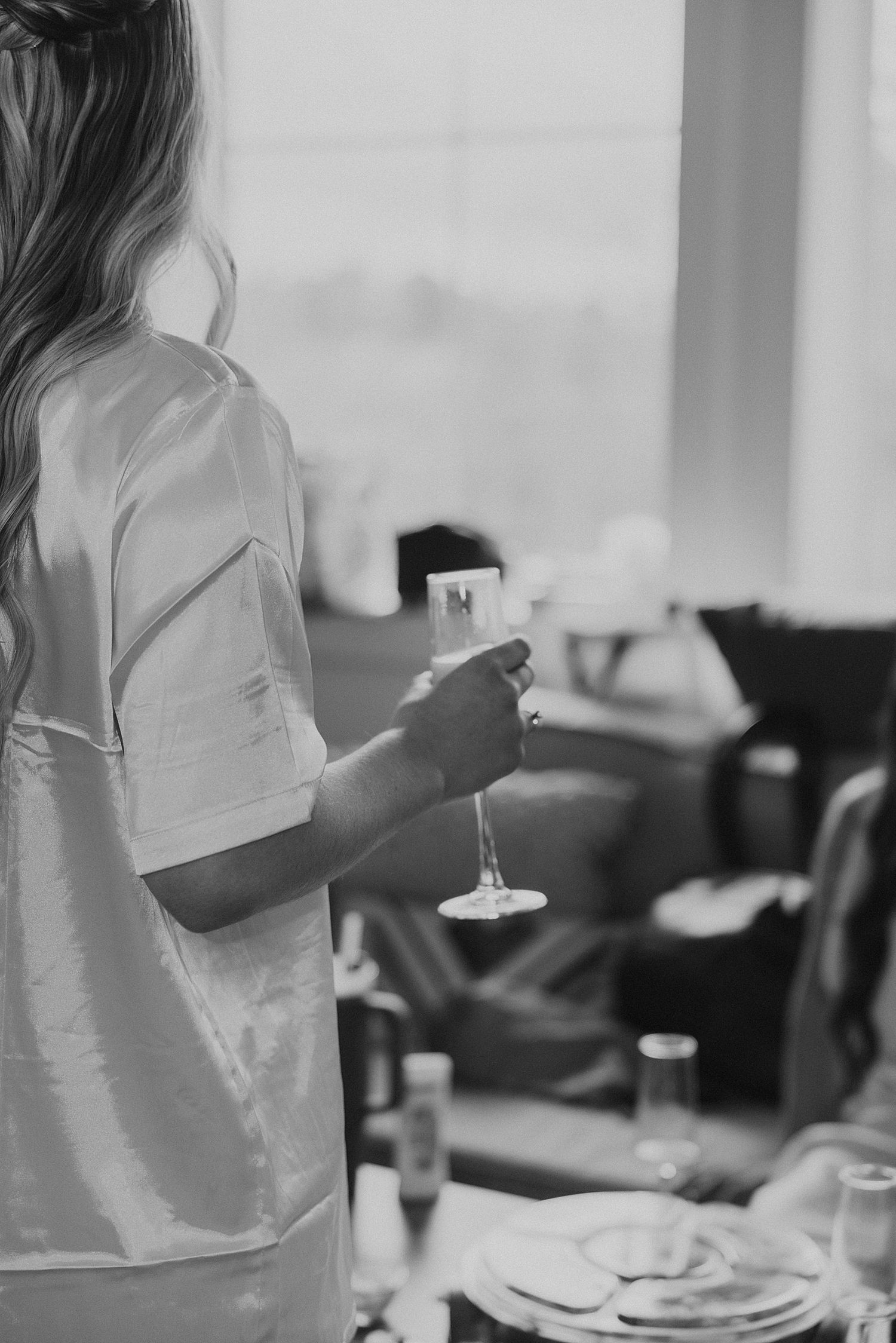 Bride having a mimosa while getting ready for her Hyla Brook Estate wedding