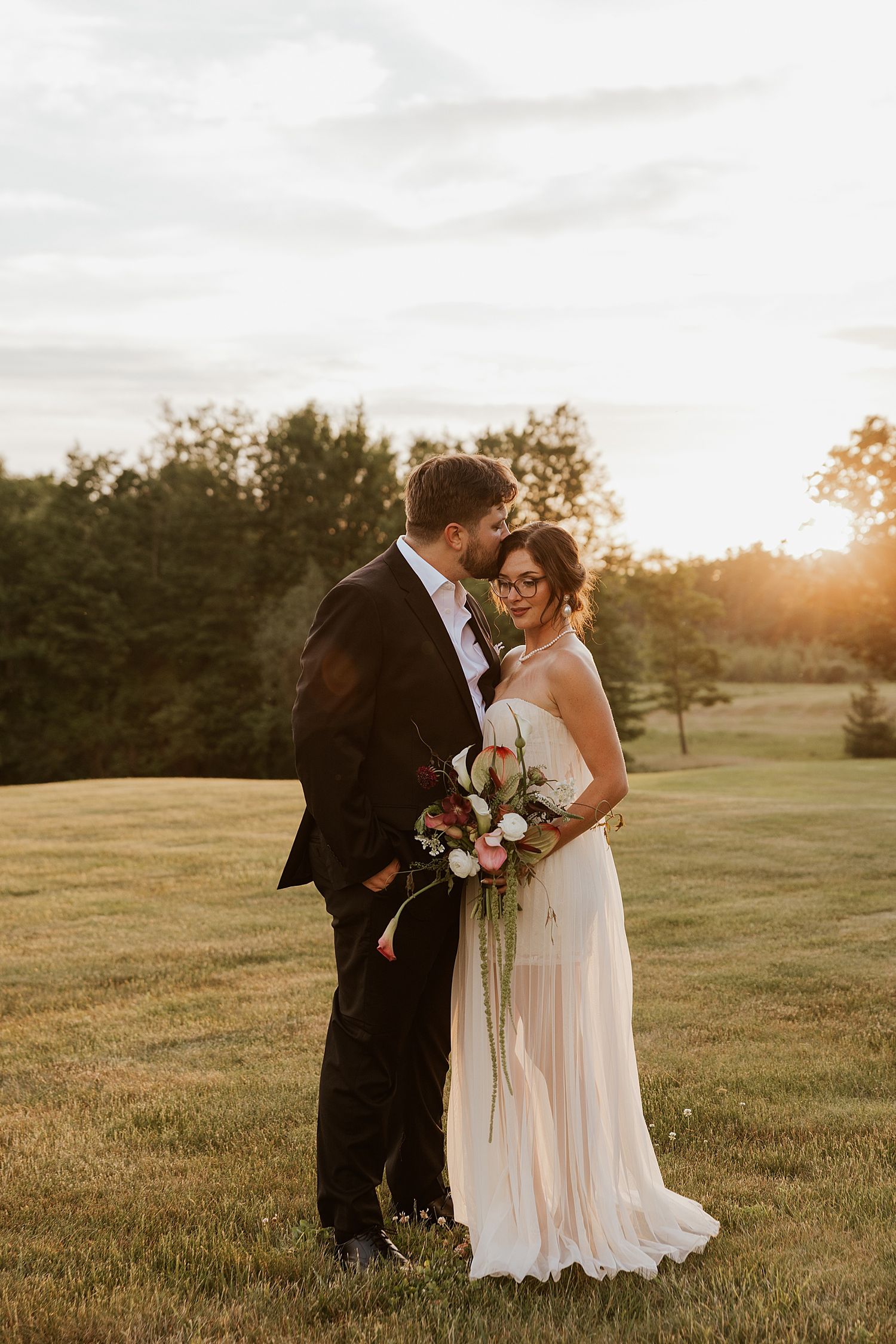 Bride and groom taking golden hour portraits at their Dell-Lea wedding in NH