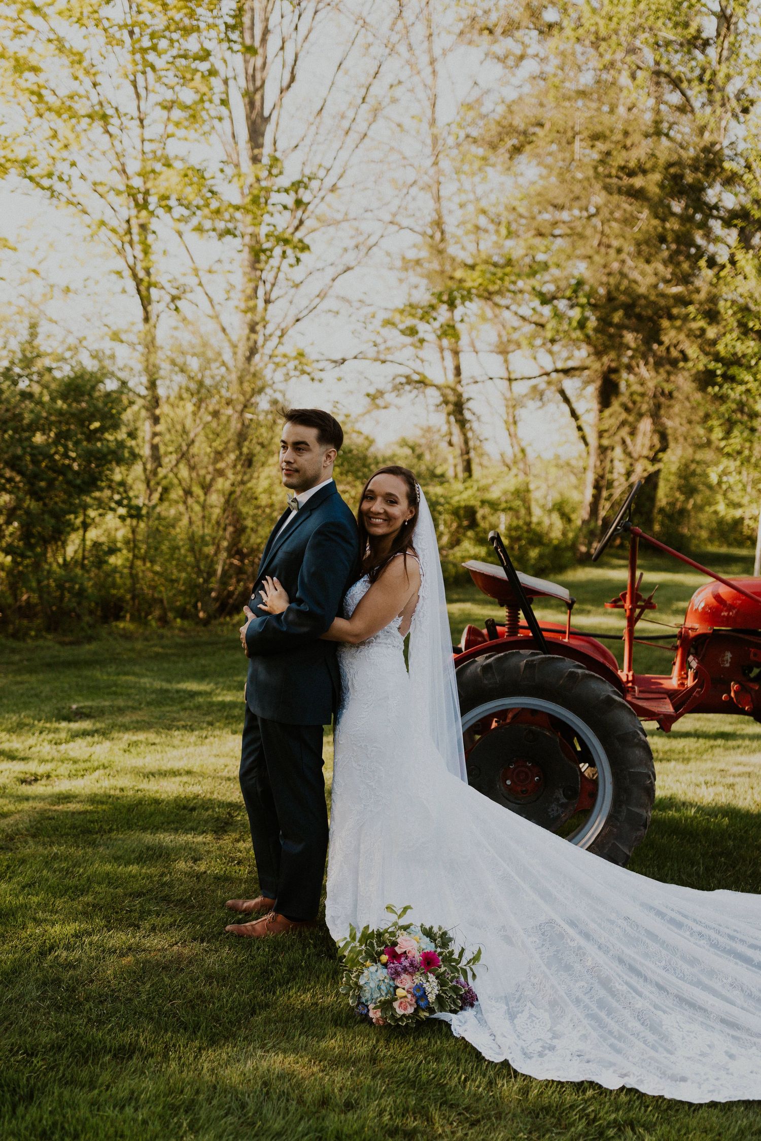 Chrissy embracing Mike for a portrait. The tractor is in the background.