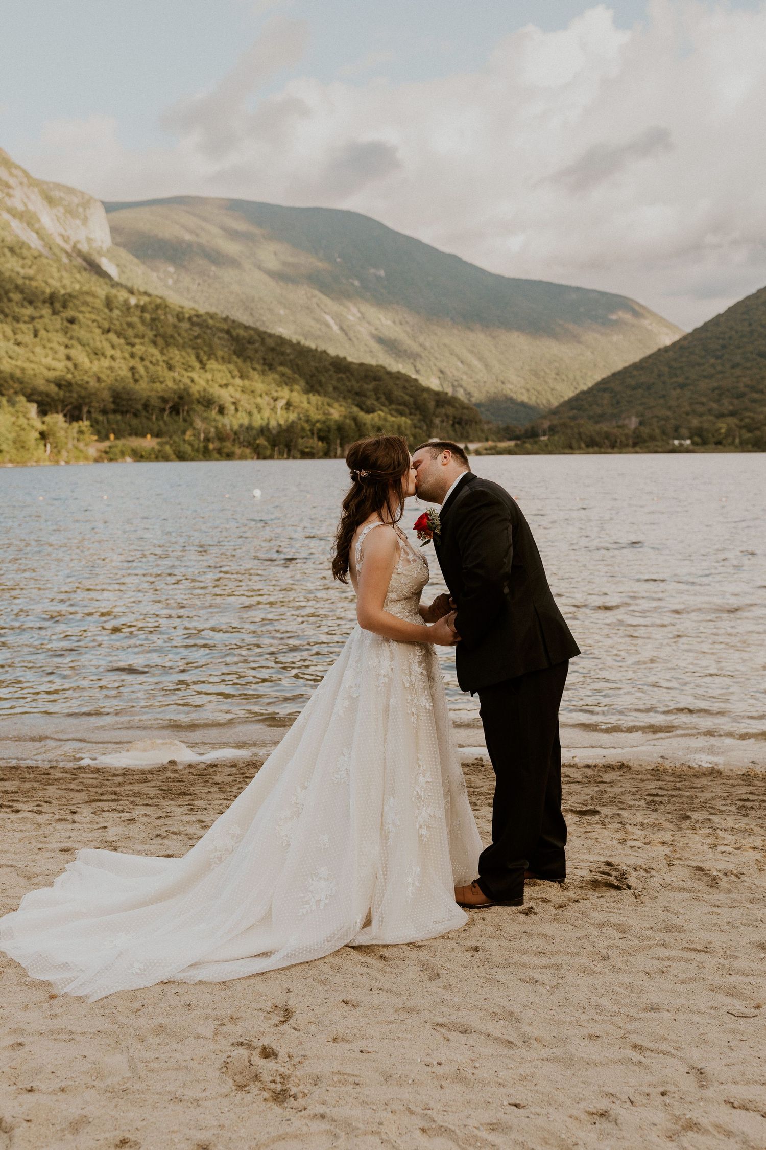 Bride and groom sharing a kiss as a way to seal their marriage during the elopement ceremony in Franconia New Hampshire.