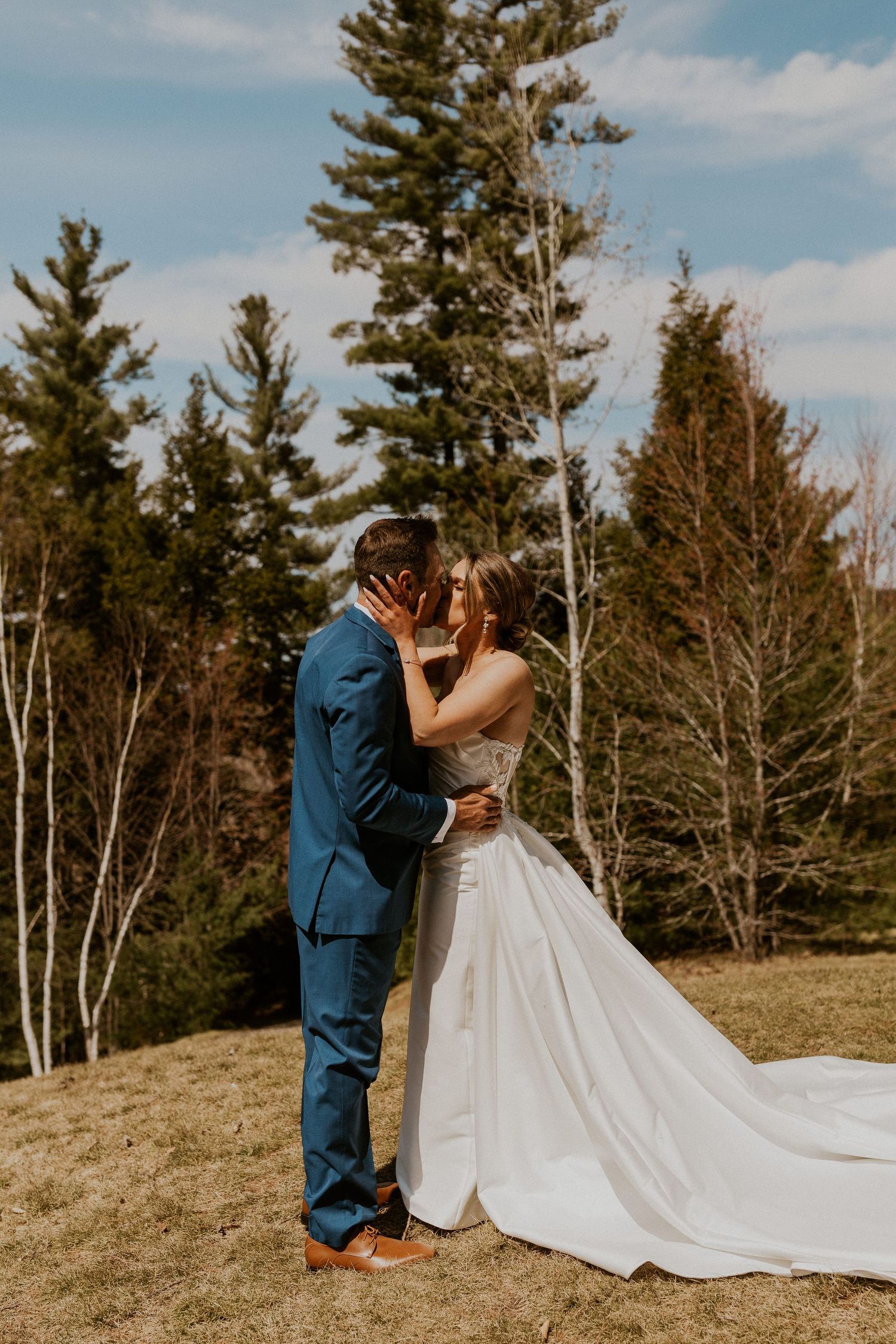 Kendra and Andrew embracing each other and kissing after seeing each other for the first time on their wedding day.