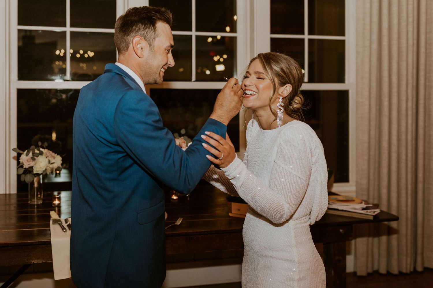 Andrew feeding the bride cake at their Owl's Nest Resort wedding.
