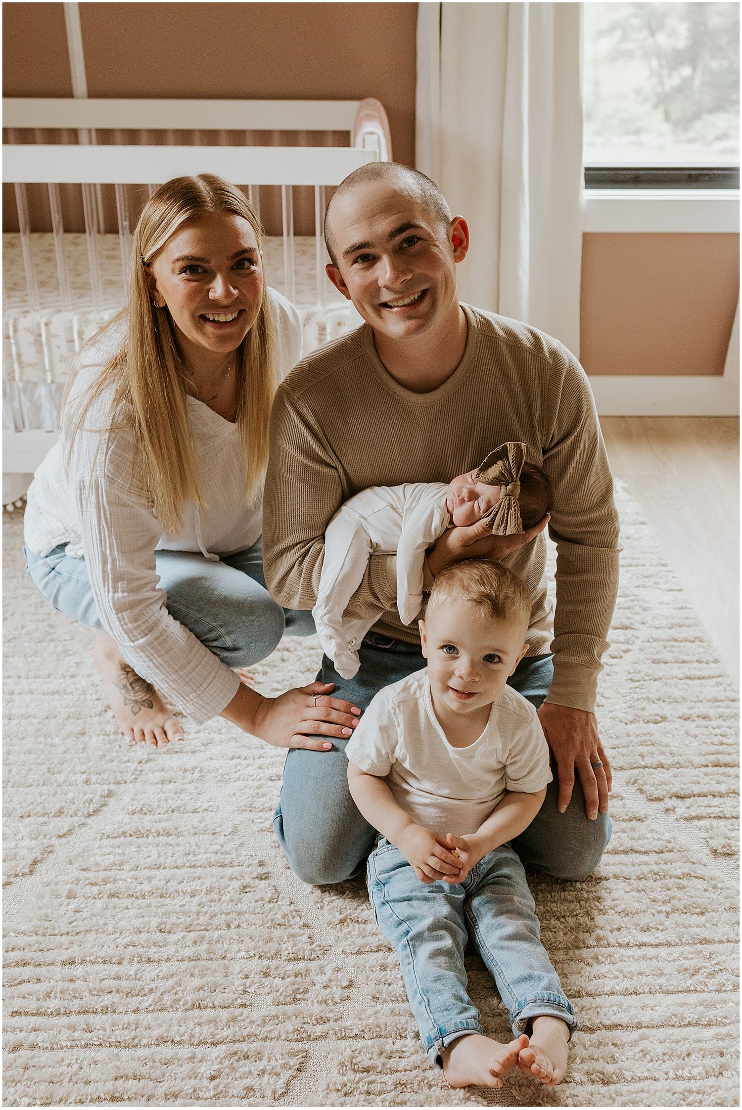 A New Hampshire family posing for lifestyle newborn family photos in their home