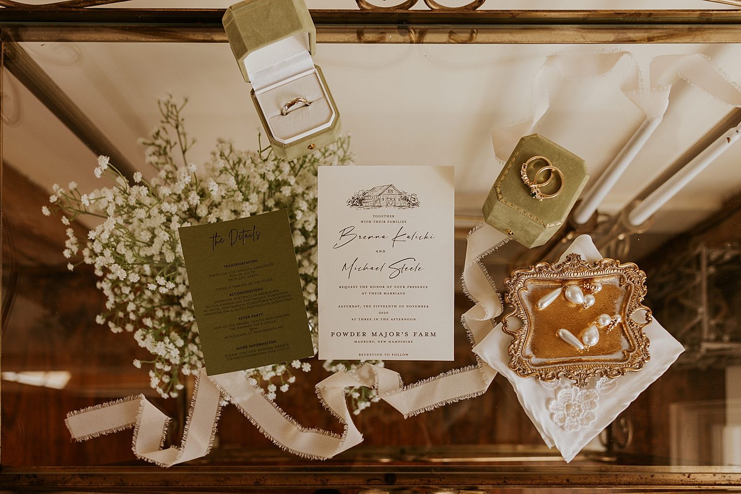 A flatlay of wedding invitations, jewelry and other bridal details for a NH wedding