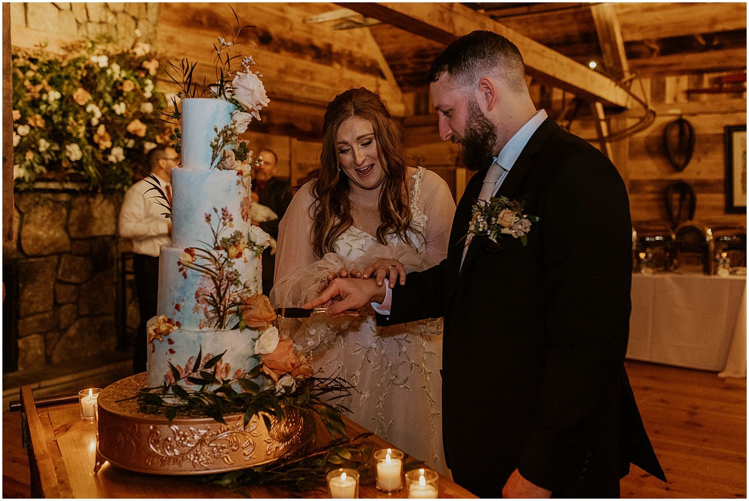 Bride and groom cutting their 4 tier floral wedding cake