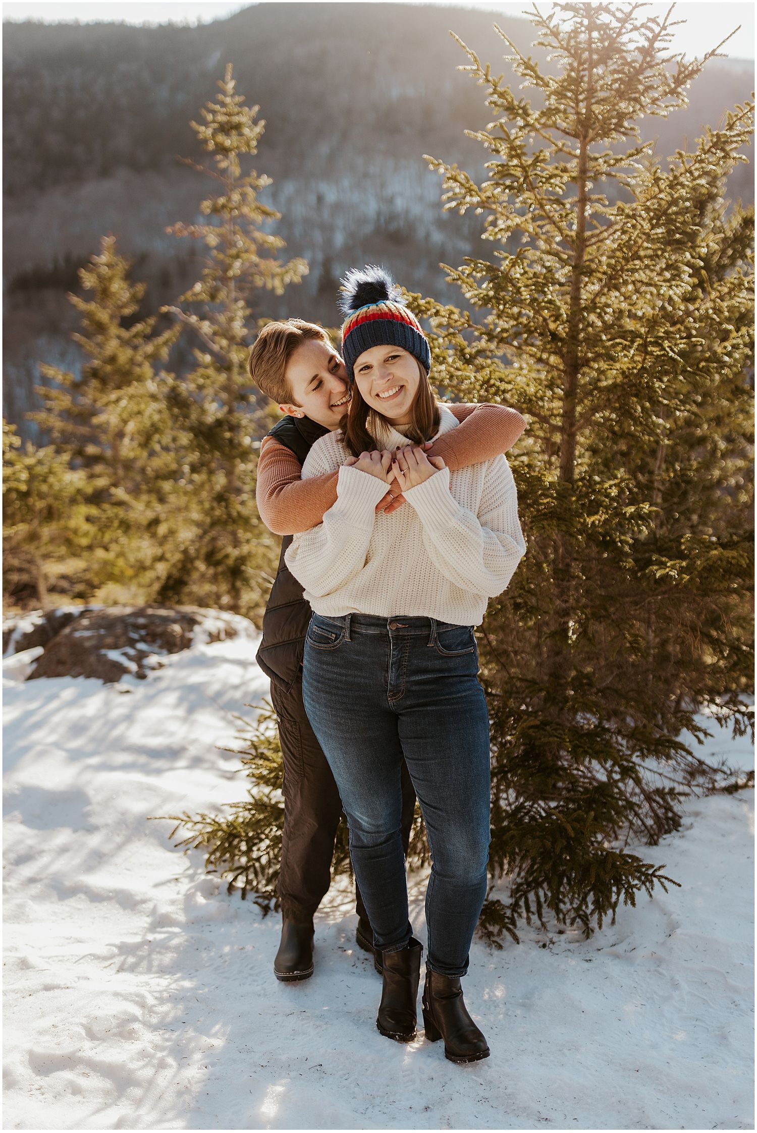 New Hampshire couple taking engagement pictures in their best winter engagement photo outfits