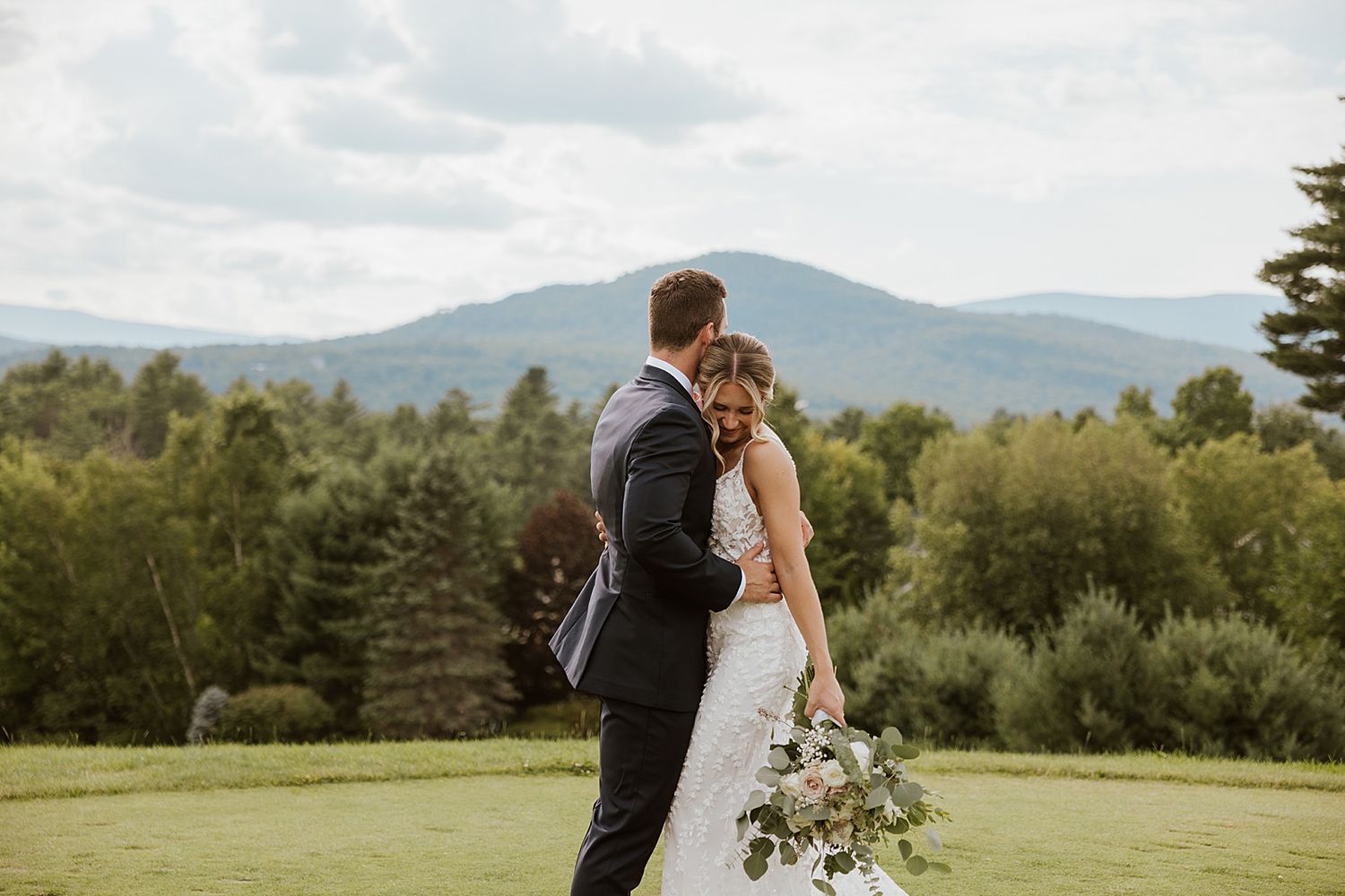 New Hampshire bride and groom taking portrait photos outside their wedding at the Sunset Pavilion at the Owl's Nest Resort