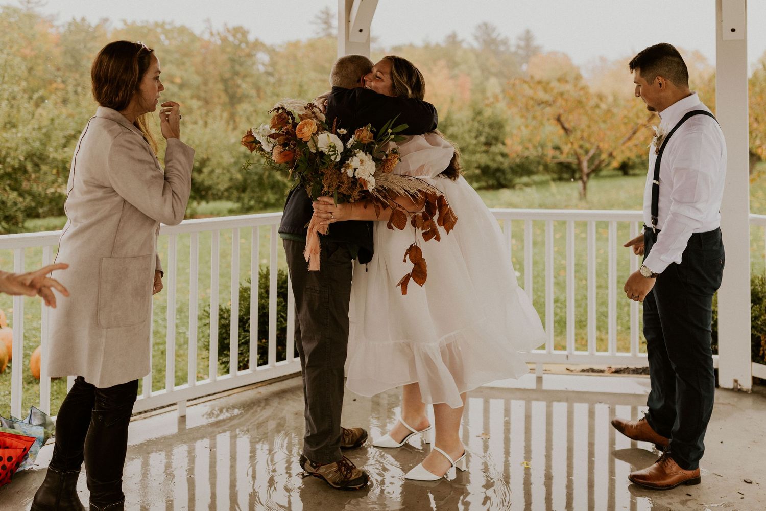 Terise hugging her parents after their intimate wedding at Carter Hill Orchard in Concord New Hampshire.