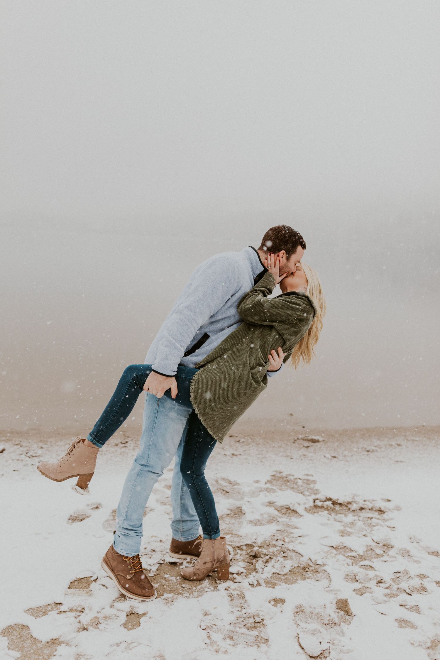 Newly engaged couple playfully posing for photos during their engagement session in Franconia New Hampshire.