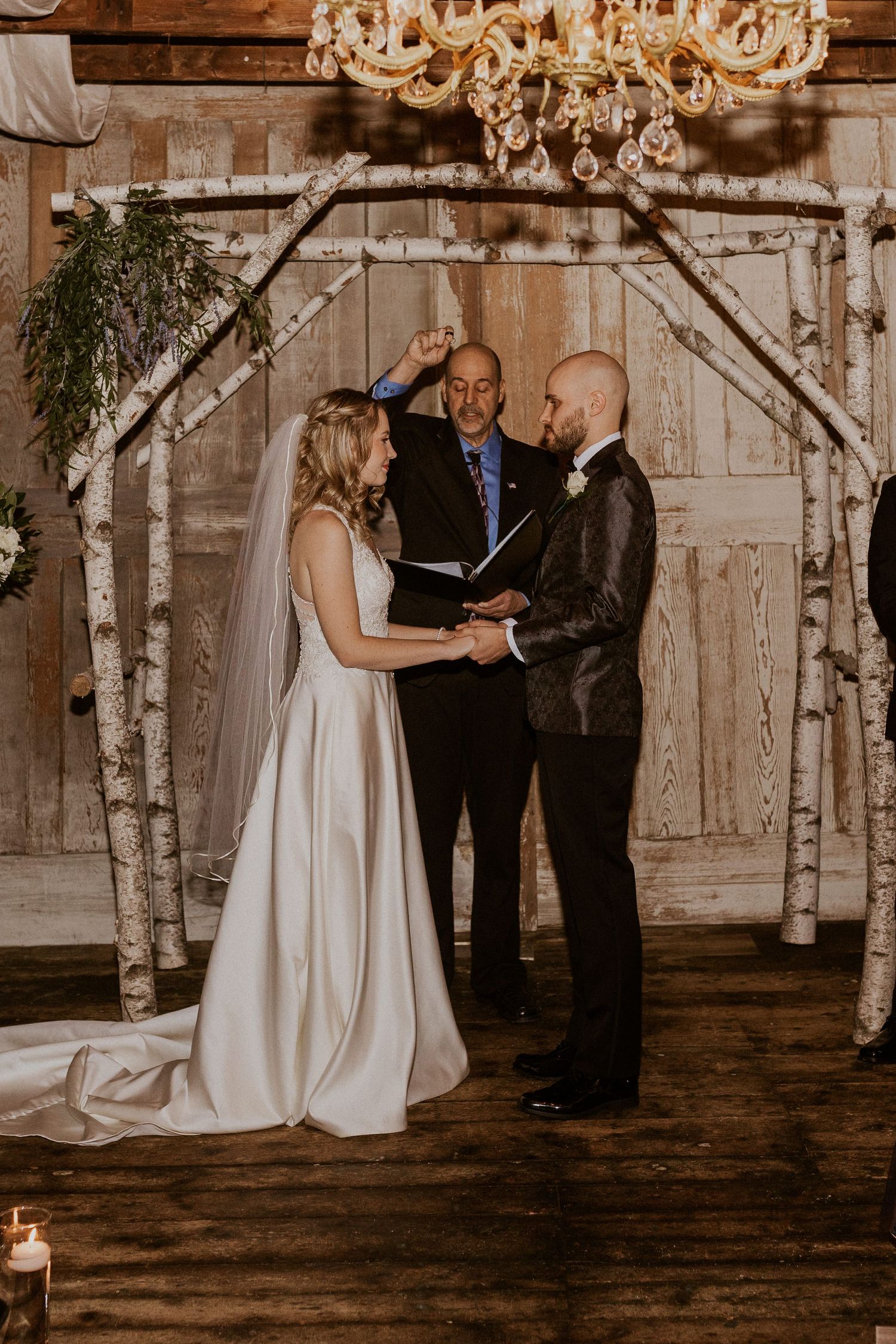 Deirdre and Brodie hand in hand during their wedding ceremony in Tamworth New Hampshire.