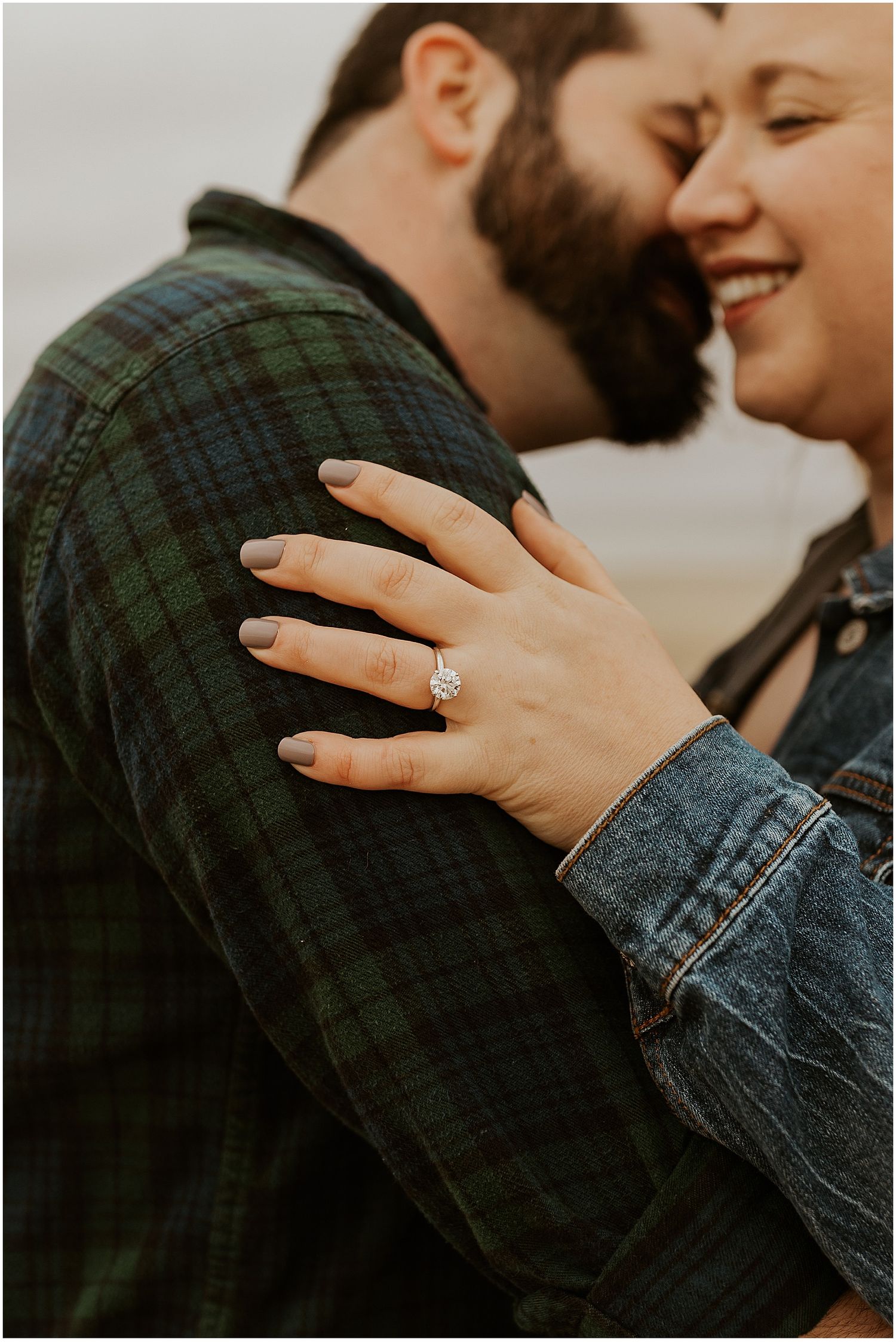 New England couple taking engagement photos at the beach