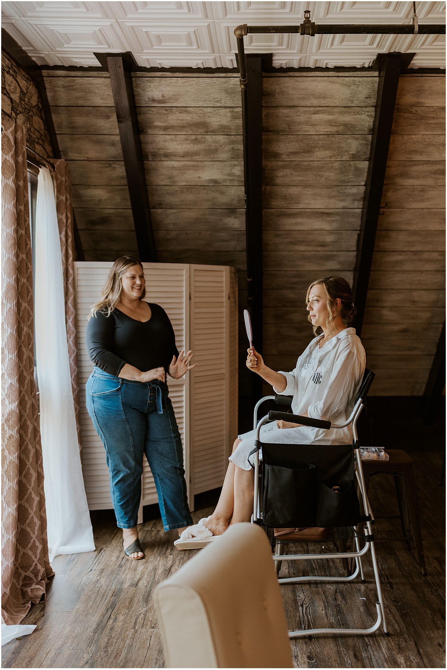 Getting ready scene in a rustic room with wooden beams and natural window light.