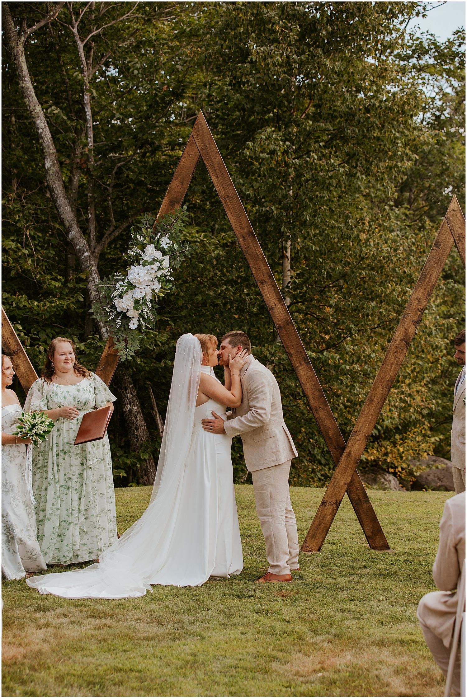 Bride and groom kissing at their Maine wedding ceremony