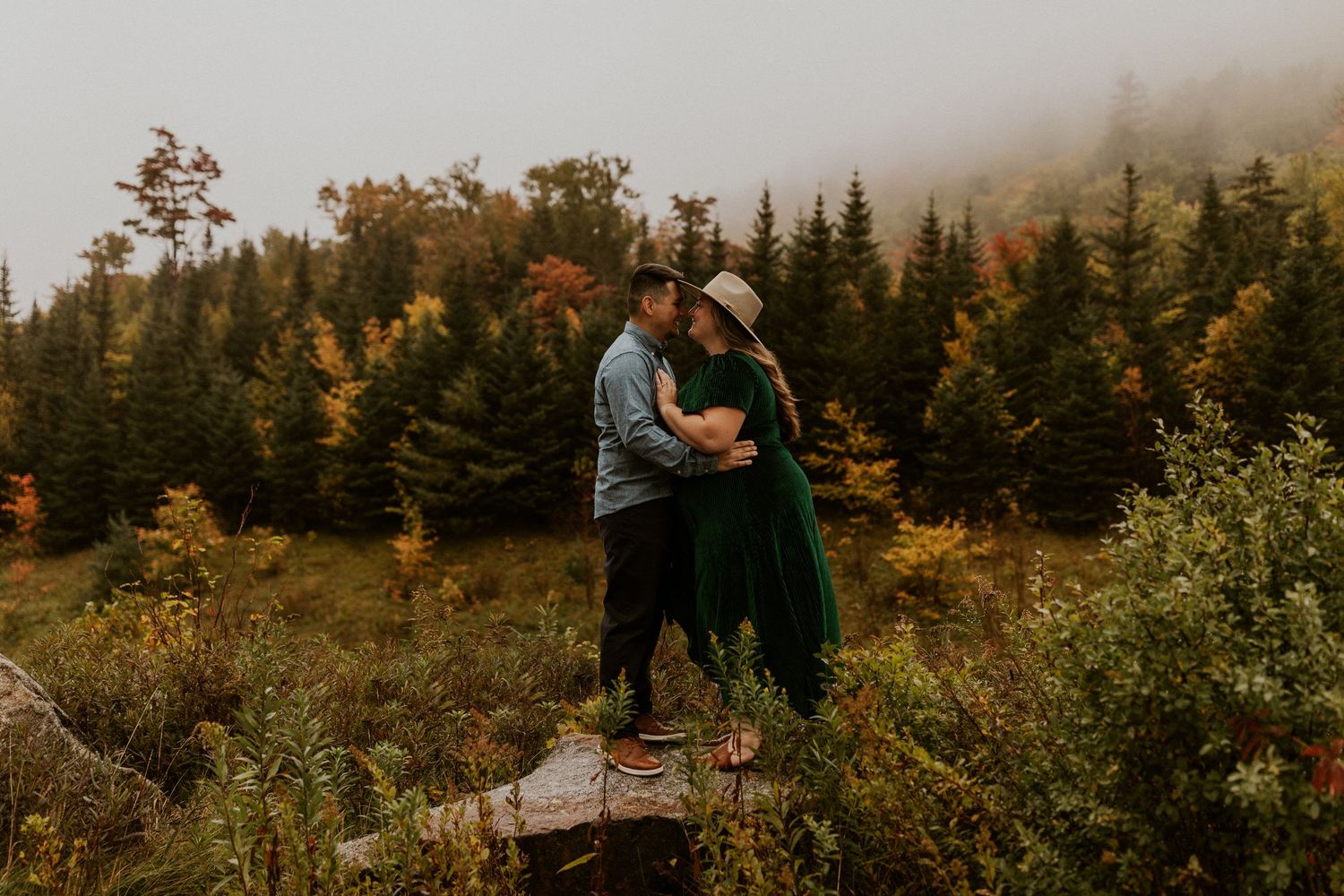 Engaged couple embracing each other during their engagement photoshoot in the white mountains of New Hampshire.