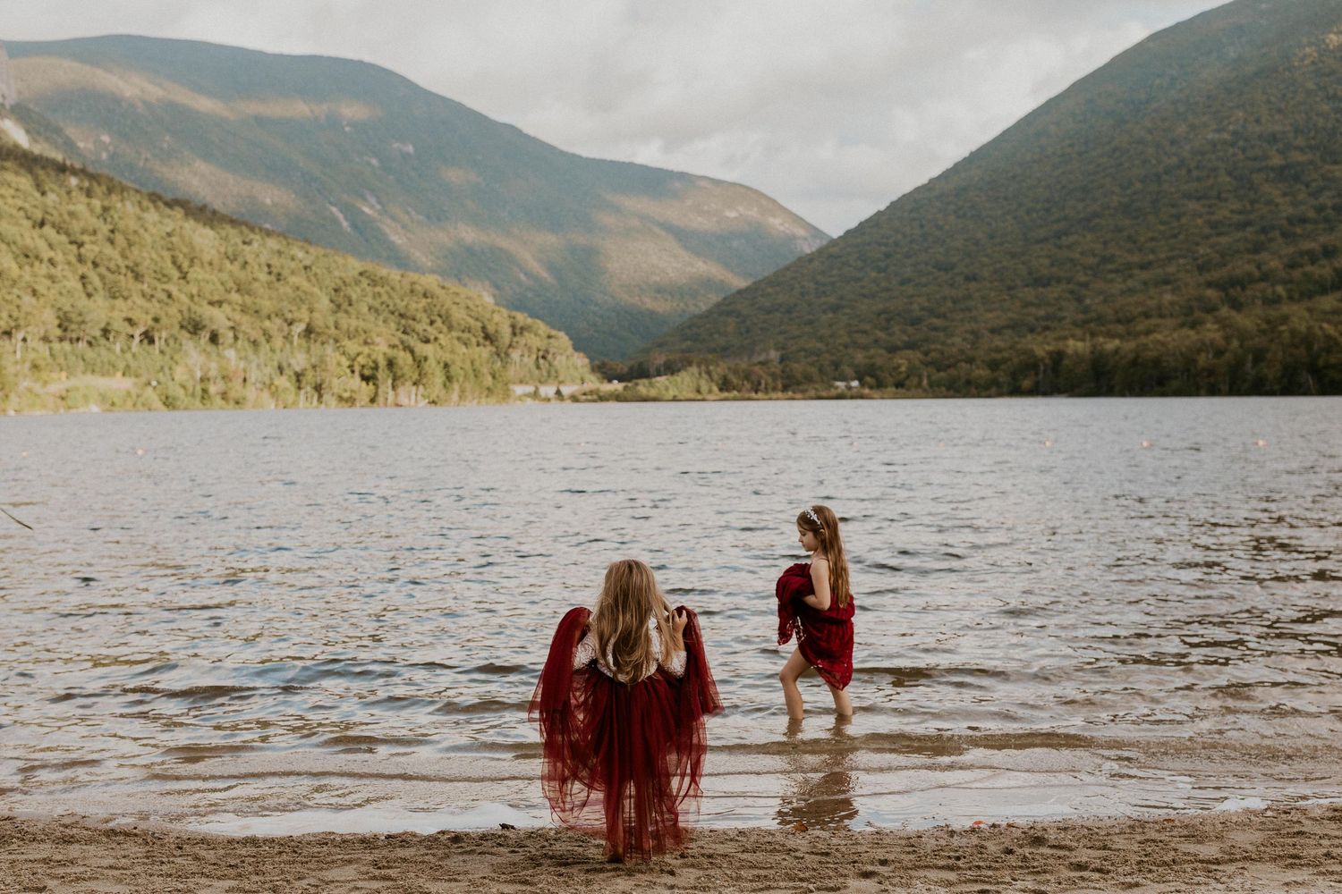 The bride and grooms daughters enjoying the lake after the elopement ceremony