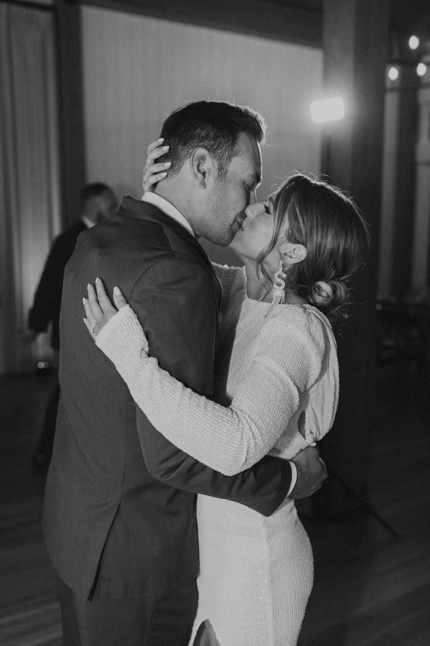 The bride and groom kissing on the dance floor at their Lake House reception at Owl's Nest Resort.
