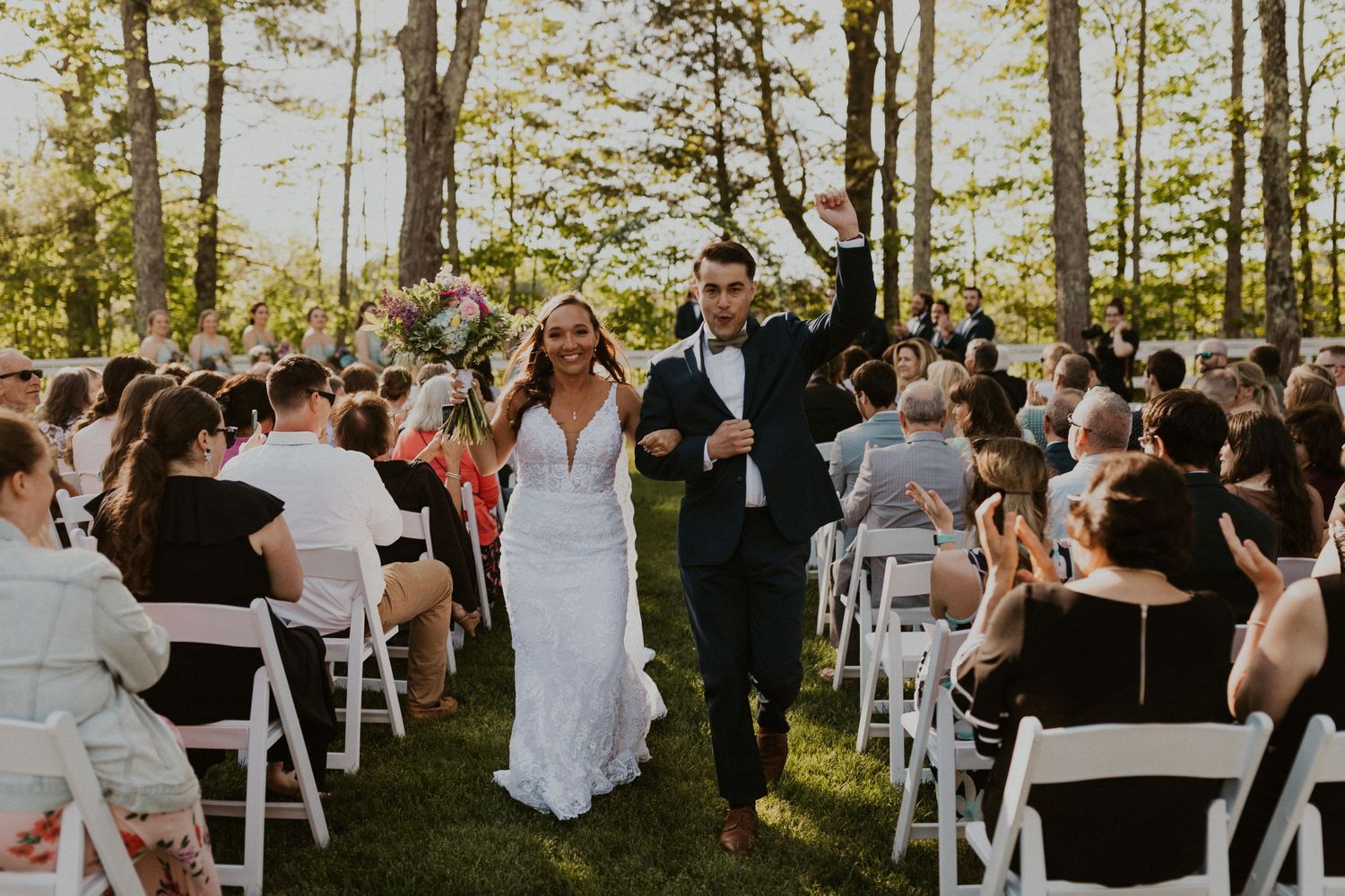 Chrissy and Mike celebrate and walk back up the aisle as newlyweds!
