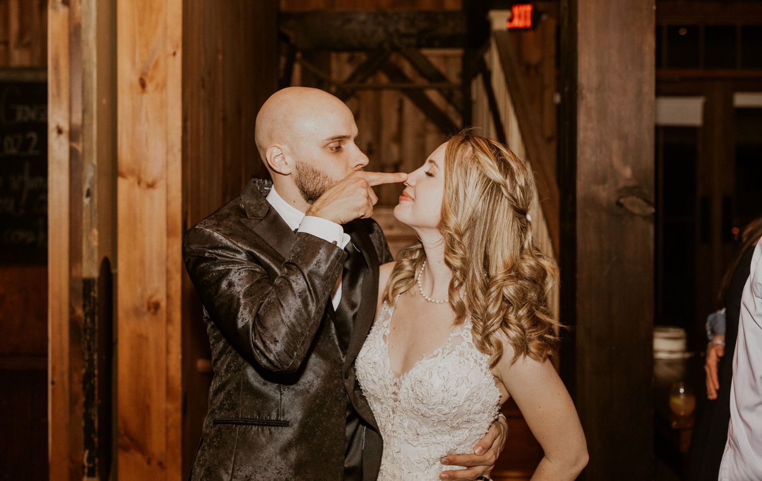 Deirdre and Brodie acting playful together toward the end of their wedding reception.