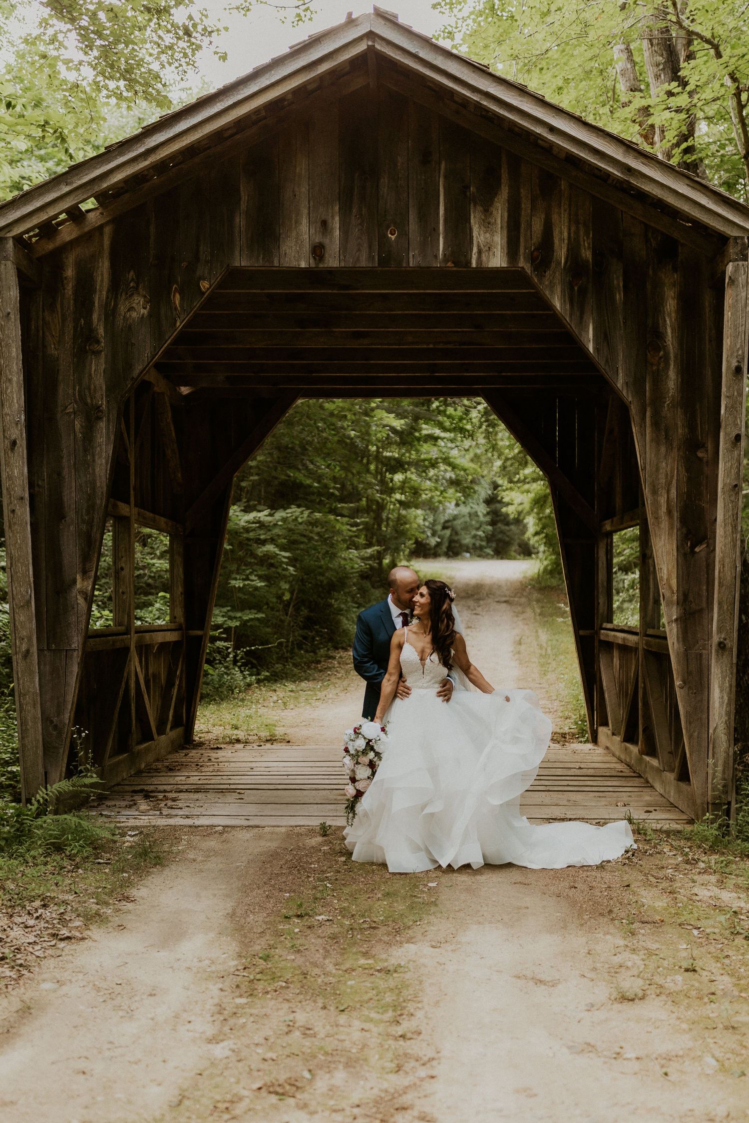 Rustic wooden covered bridge in a forest setting captured from multiple angles.