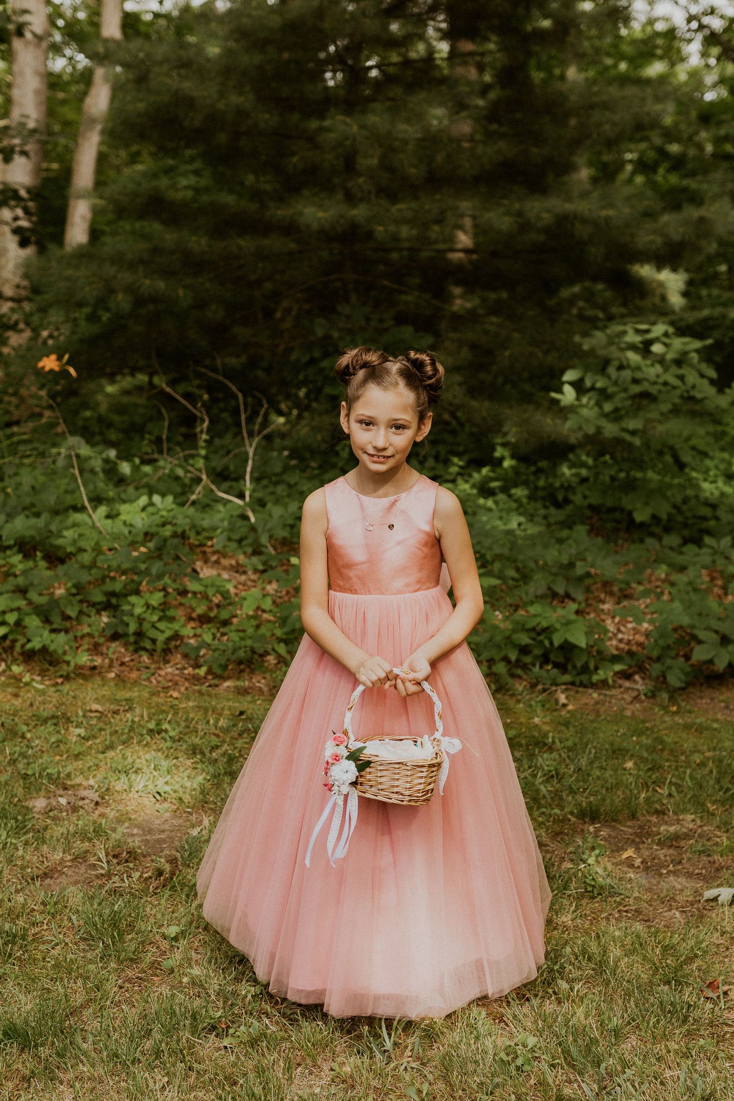 The flower girl smiling for a portrait.
