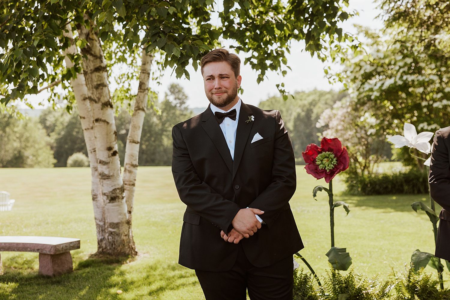 Groom waiting for his bride to walk down the aisle at an outdoor wedding ceremony in New Hampshire