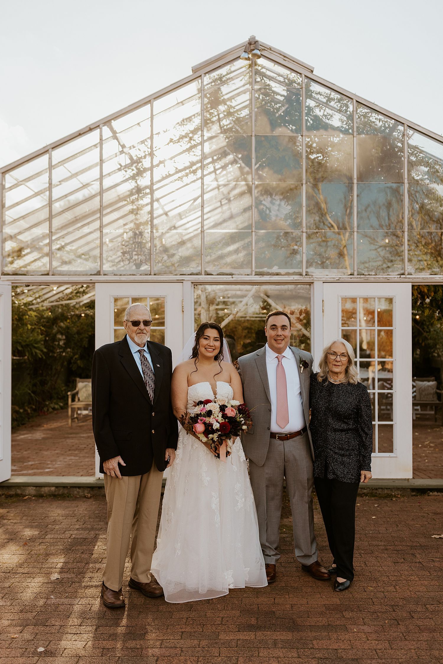 Couple posing with the bride's parents at a New Hampshire wedding
