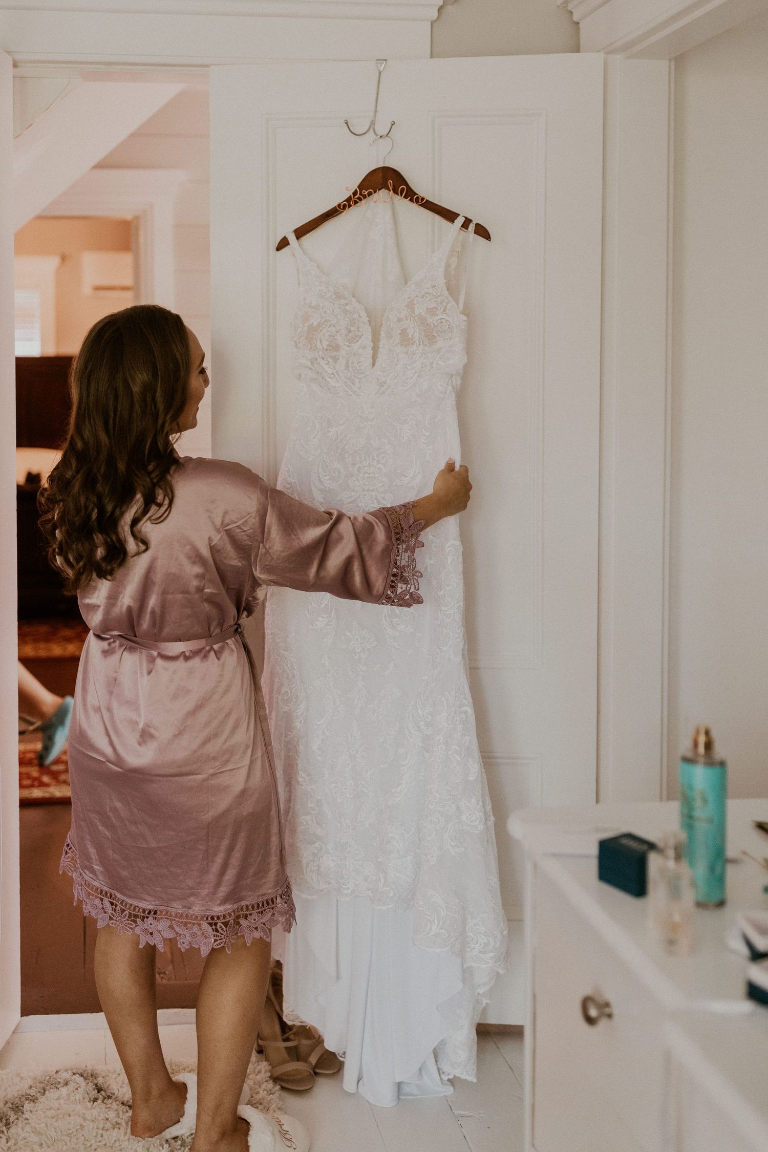 Chrissy admiring her dress before it's time to put it on