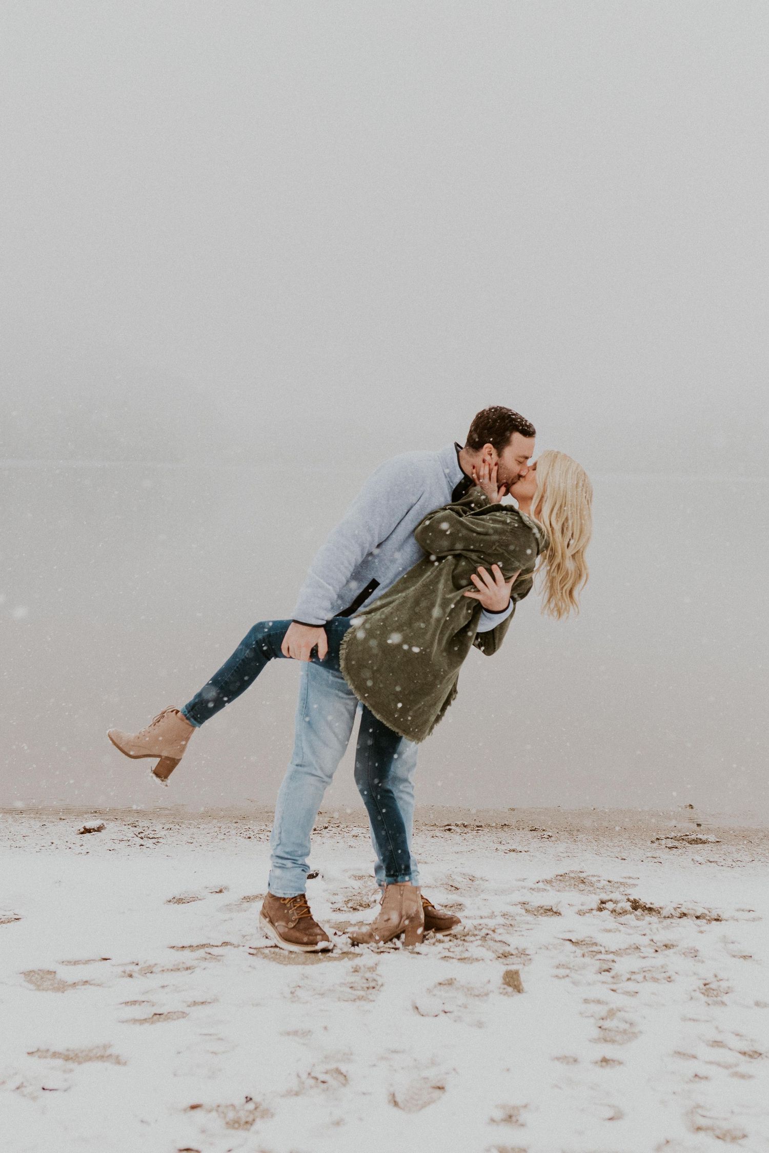 Newly engaged couple playfully posing for photos during their engagement session in Franconia New Hampshire.