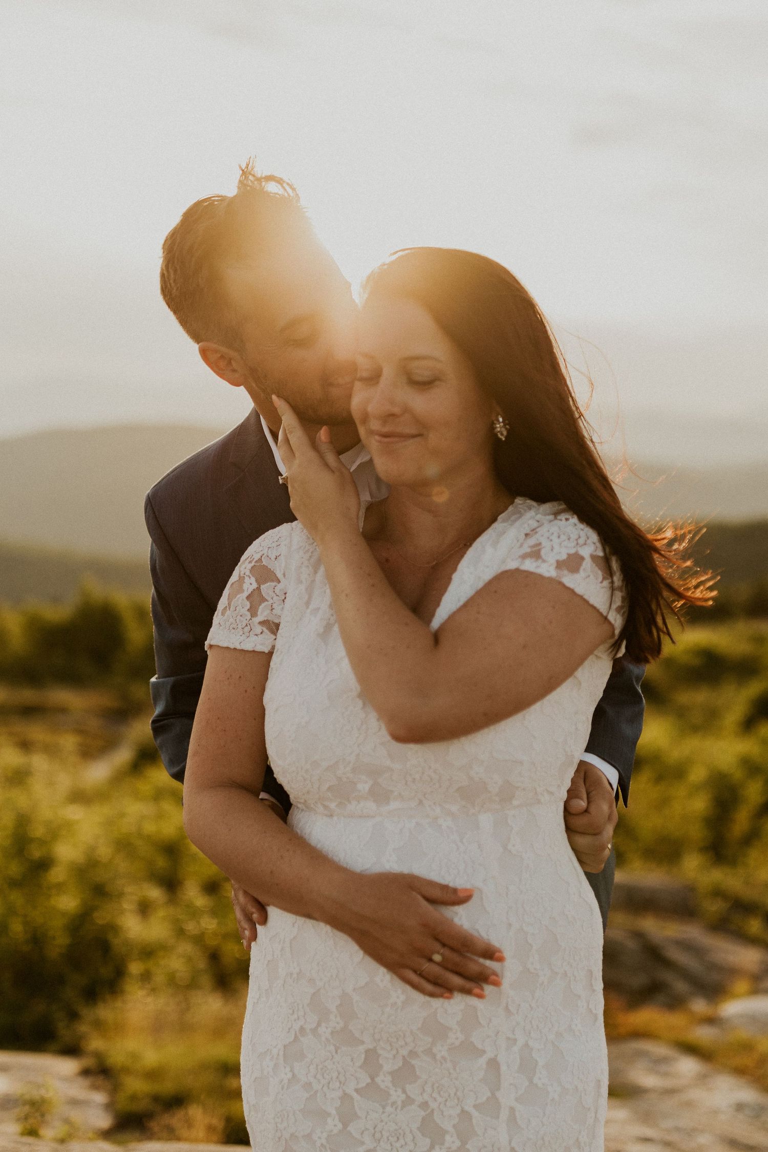 Danielle and Colin dressed in their wedding attire for their one year anniversary photoshoot on Foss Mountain in NH.