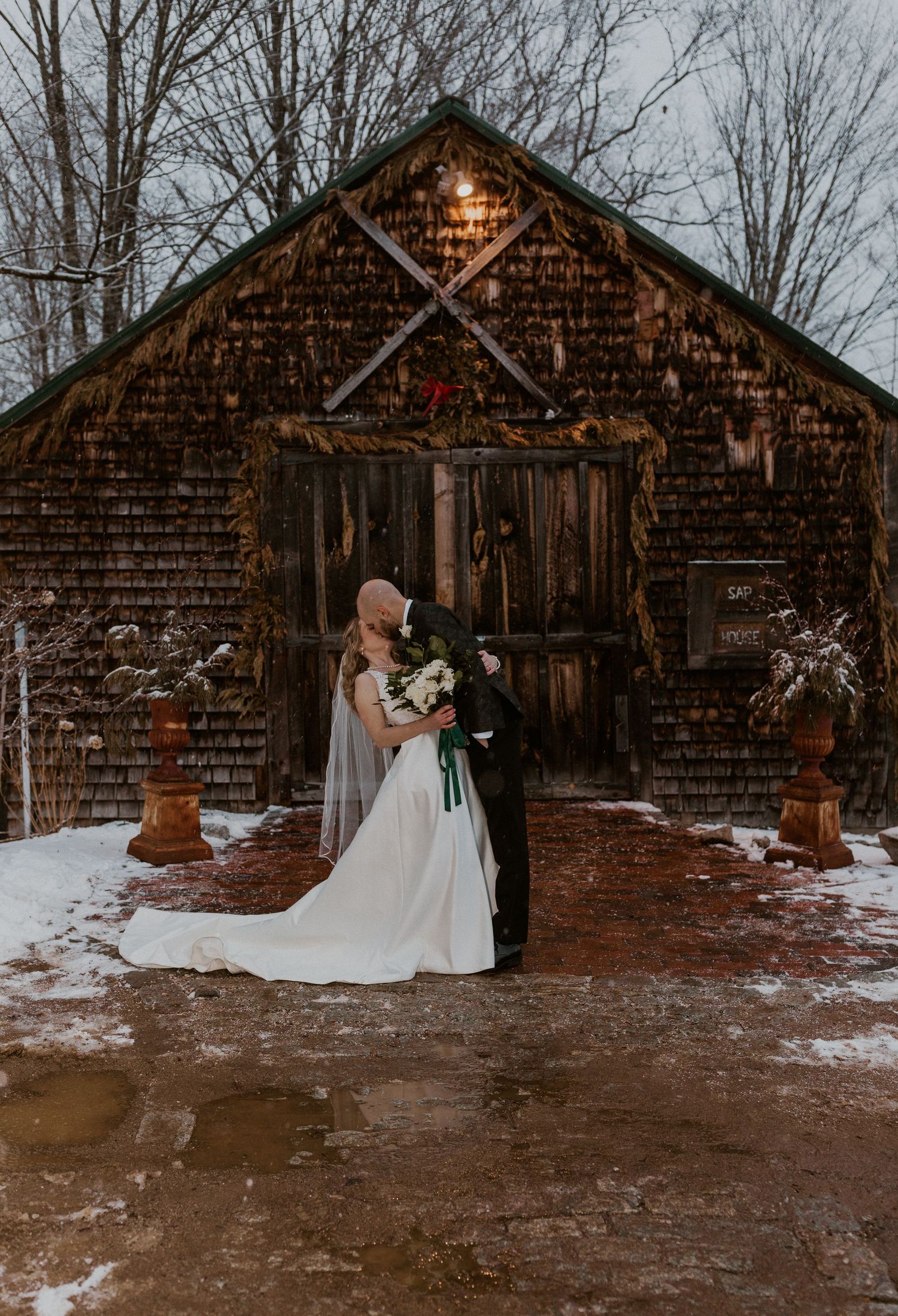 Brodie dipping and kissing Deirdre in front of the sap house at The Preserve in Tamworth New Hampshire.