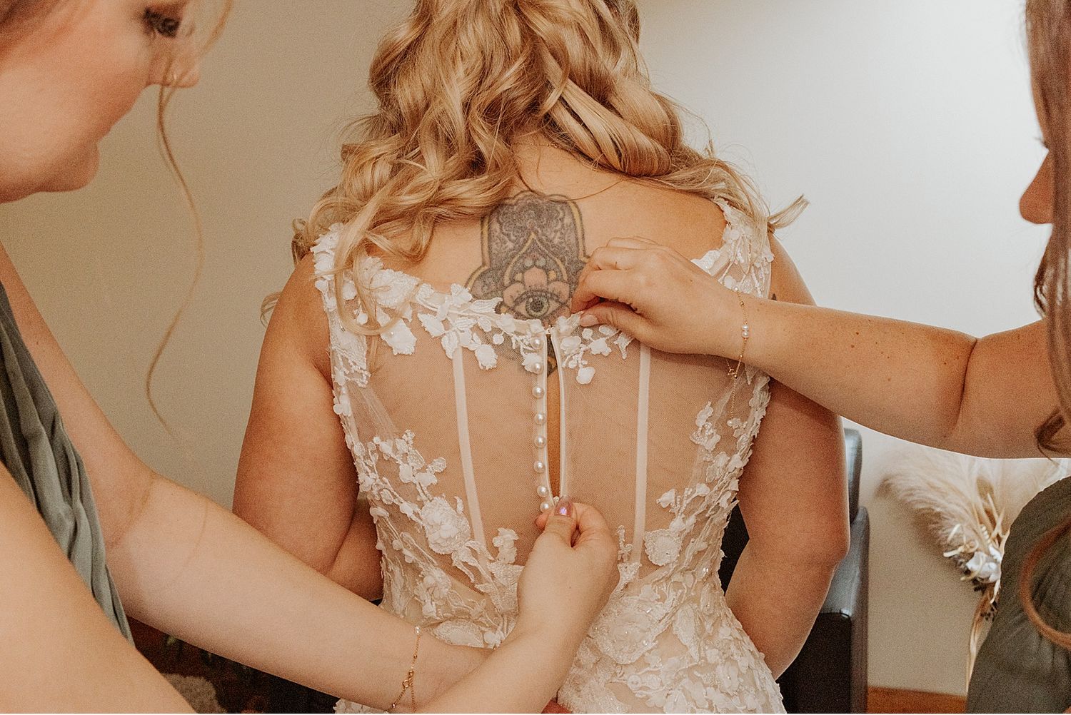 Close-up details of a romantic lace wedding gown with sheer elements.
