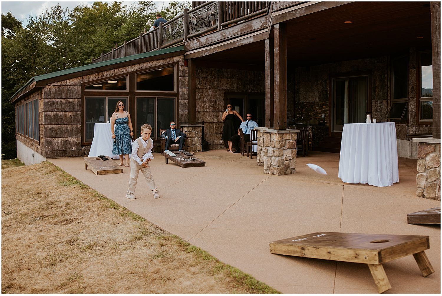Guests playing lawn games at a VRBO wedding in Maine