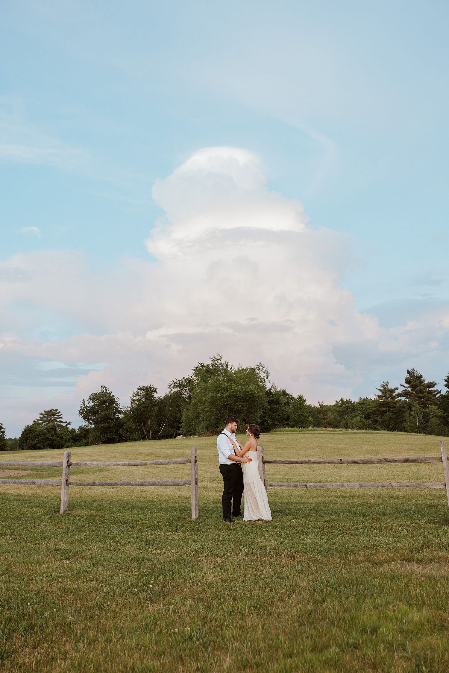 NH bride and groom taking golden hour portraits in a field at their Dell-Lea wedding