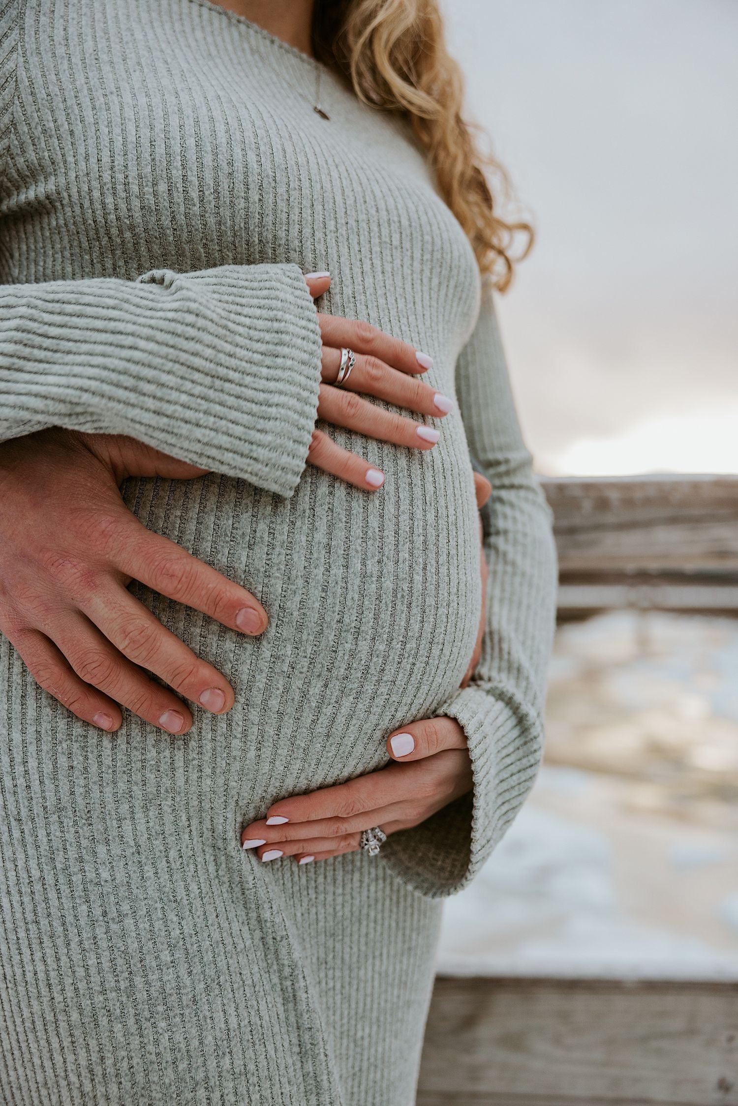 Couple taking snowy maternity photos in New Hampshire
