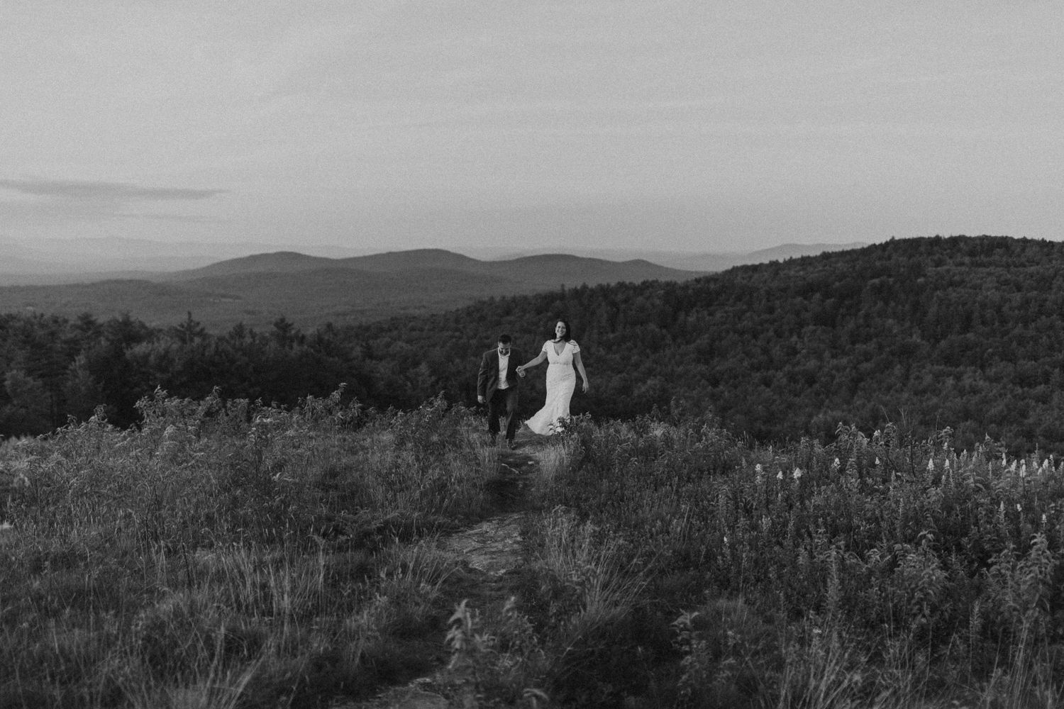 Danielle and Colin dressed in their wedding attire for their one year anniversary photoshoot on Foss Mountain in NH.