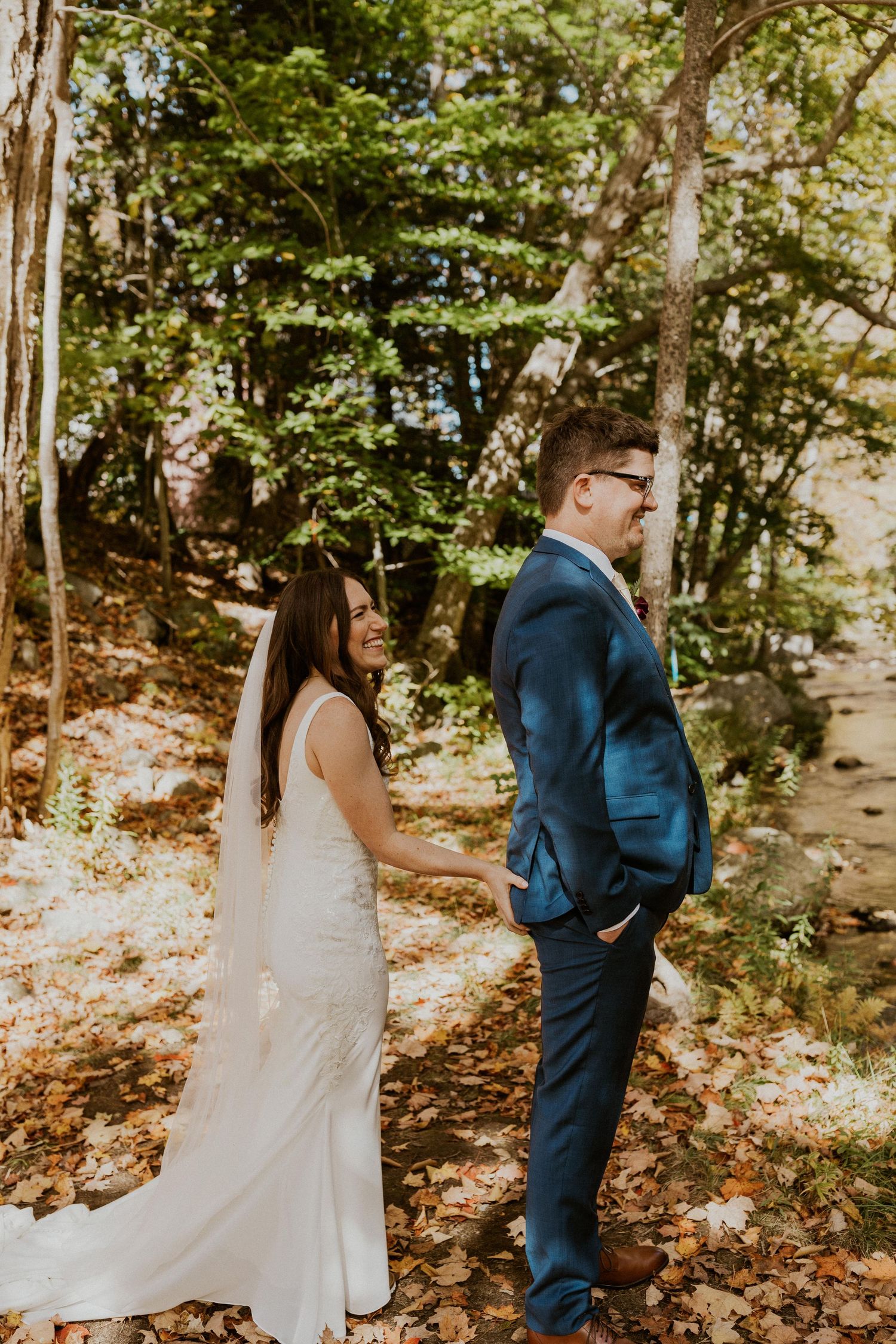 Briana squeezing Daniel's butt to signal that he can turn around and see her now.