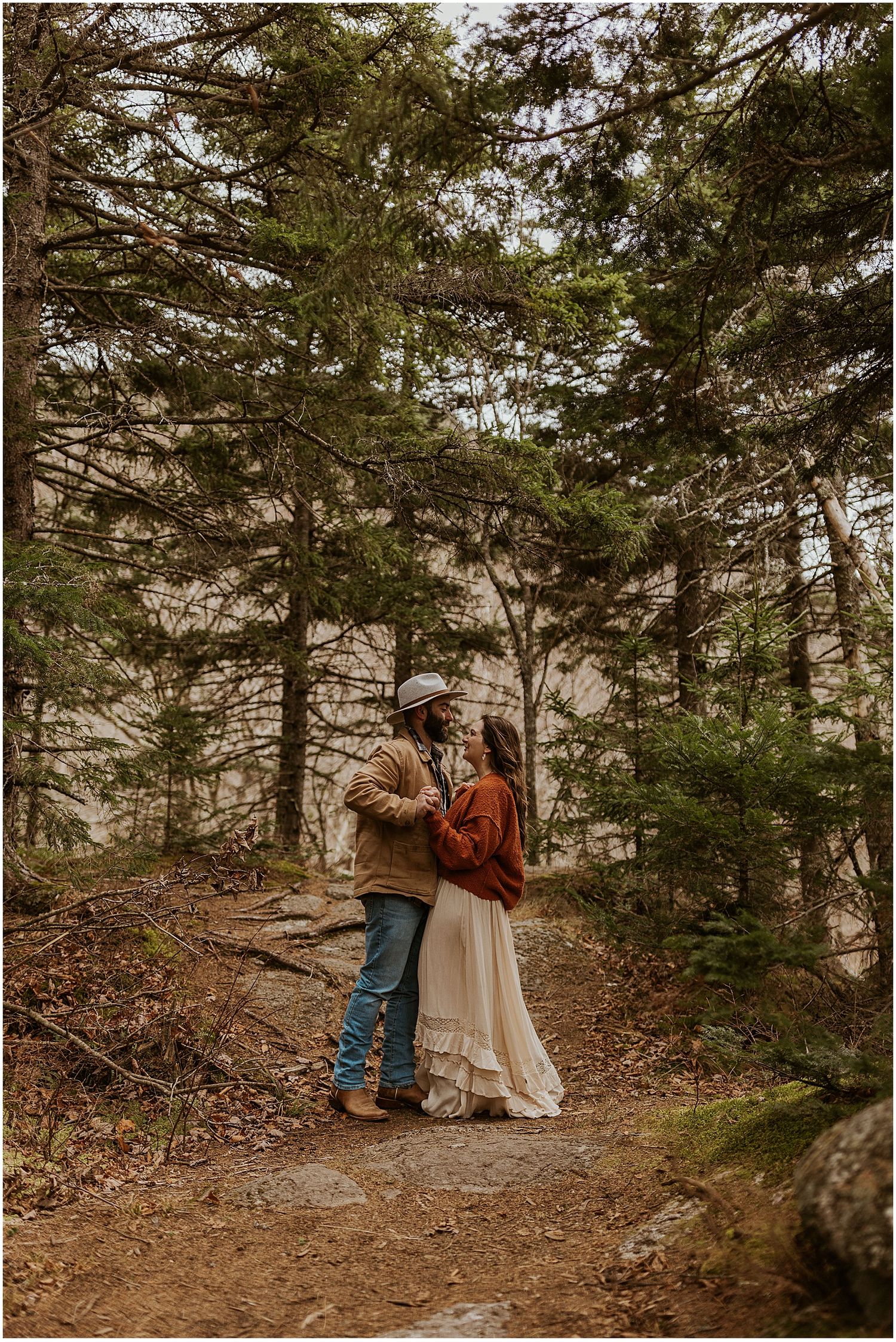 Couple taking engagement photos in the NH White Mountain National Forest