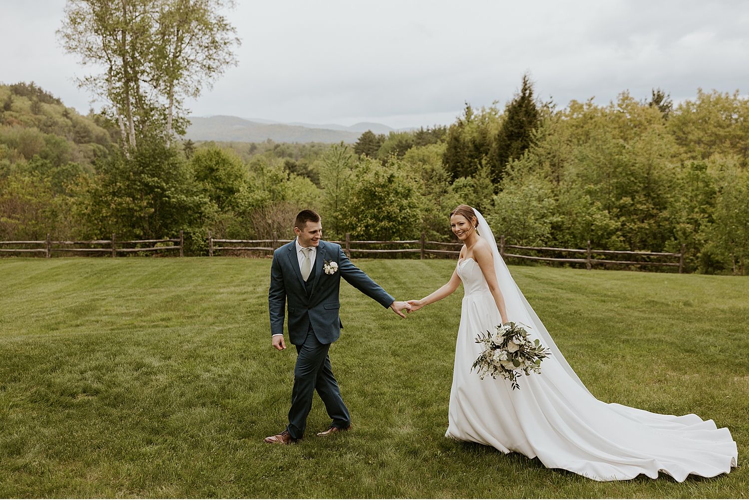 Couple walking through a scenic outdoor garden setting on their wedding day.