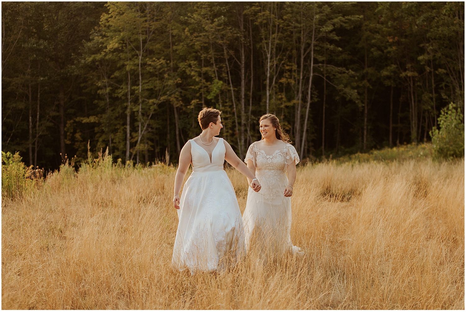 Brides taking golden hour portrait photos at their New Hampshire wedding